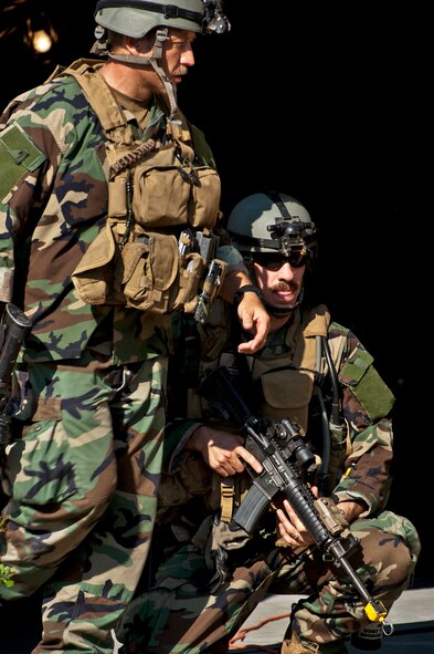 Maj. Jeff Schmidt, team leader, and Capt. Robert Rennell, intelligence officer, react to the sound of a firefight west of their camp during the Combat Aviation Advisor course’s Raven Claw exercise May 24 at Duke Field, Fla.  As part of the exercise, 19 CAA students deployed to a foreign nation to advise and train their air forces in fixed wing and rotary aircraft operations.  The four-day exercise is the capstone of 12 weeks of baseline certification training for CAA.  The year-long process to become a CAA also includes months of language and flight training.  (U.S. Air Force photo/Tech. Sgt. Samuel King Jr.)