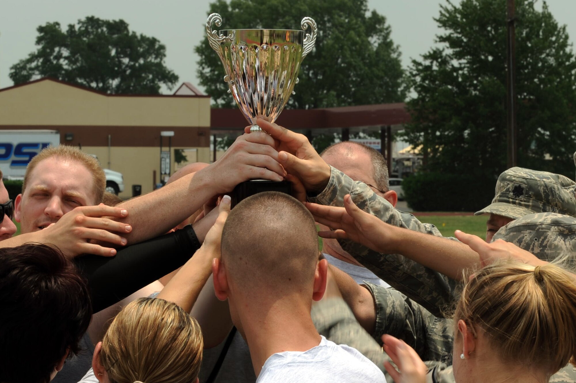 Airmen from the 26th Operational Weather Squadron celebrate on Barksdale Air Force Base, La., May 25. The squadron took first place during the 2nd Bomb Wing Sports Day, which consisted of a basketball tournament, football tournament, bicycle time trial, push-up competition, tug-of-war, volleyball competition, racquetball competition and a rucksack relay. (U.S. Air Force photo/Airman 1st Class Micaiah Anthony) (RELEASED)

