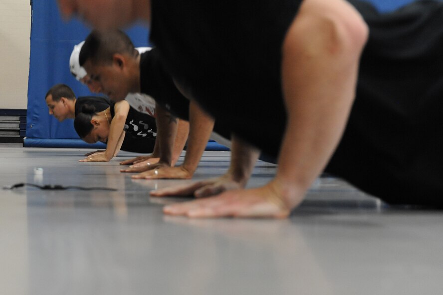 Airmen from the 2nd Civil Engineer Squadron do push-ups during the 2nd Bomb Wing Sports Day push-up competition on Barksdale Air Force Base, La., May 25. Sports day was organized by the 2nd Force Support Squadron to build unit morale and boost physical fitness for May Fitness Month. (U.S. Air Force photo/Airman 1st Class Micaiah Anthony) (RELEASED)