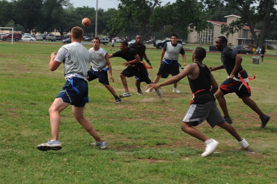 An Airman from the 2nd Operations Support Squadron runs to catch a pass against the 2nd Civil Engineer Squadron during the 2nd Bomb Wing Sports Day football tournament on Barksdale Air Force Base, La., May 25. Sports Day is comprised of various competitive athletic events to help promote physical fitness. (U.S. Air Force photo/Airman 1st Class Micaiah Anthony) (RELEASED)