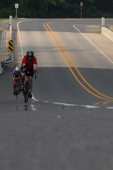 Participants in the 2nd Bomb Wing Sports Day bicycle time trial ride up a hill on the East Reservation on Barksdale Air Force Base, La., May 25. The race accommodated both mountain bikes and road bikes for the 12-mile journey. The fastest time for the course was 21:59 by Master Sgt. Andrew Chocha, Air Force Global Strike Command, with an average speed of 32.75 mph. (U.S. Air Force photo/Airman 1st Class Micaiah Anthony) (RELEASED)