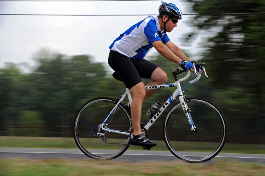 A participant of the 2nd Bomb Wing Sports Day bicycle time trial rides his bike on the East Reservation on Barksdale Air Force Base, La., May 25. The race accommodated both mountain bikes and road bikes for the 12-mile journey. The fastest time for the course was 21:59 by Master Sgt. Andrew Chocha, Air Force Global Strike Command, with an average speed of 32.75 mph. (U.S. Air Force photo/Airman 1st Class Micaiah Anthony) (RELEASED)