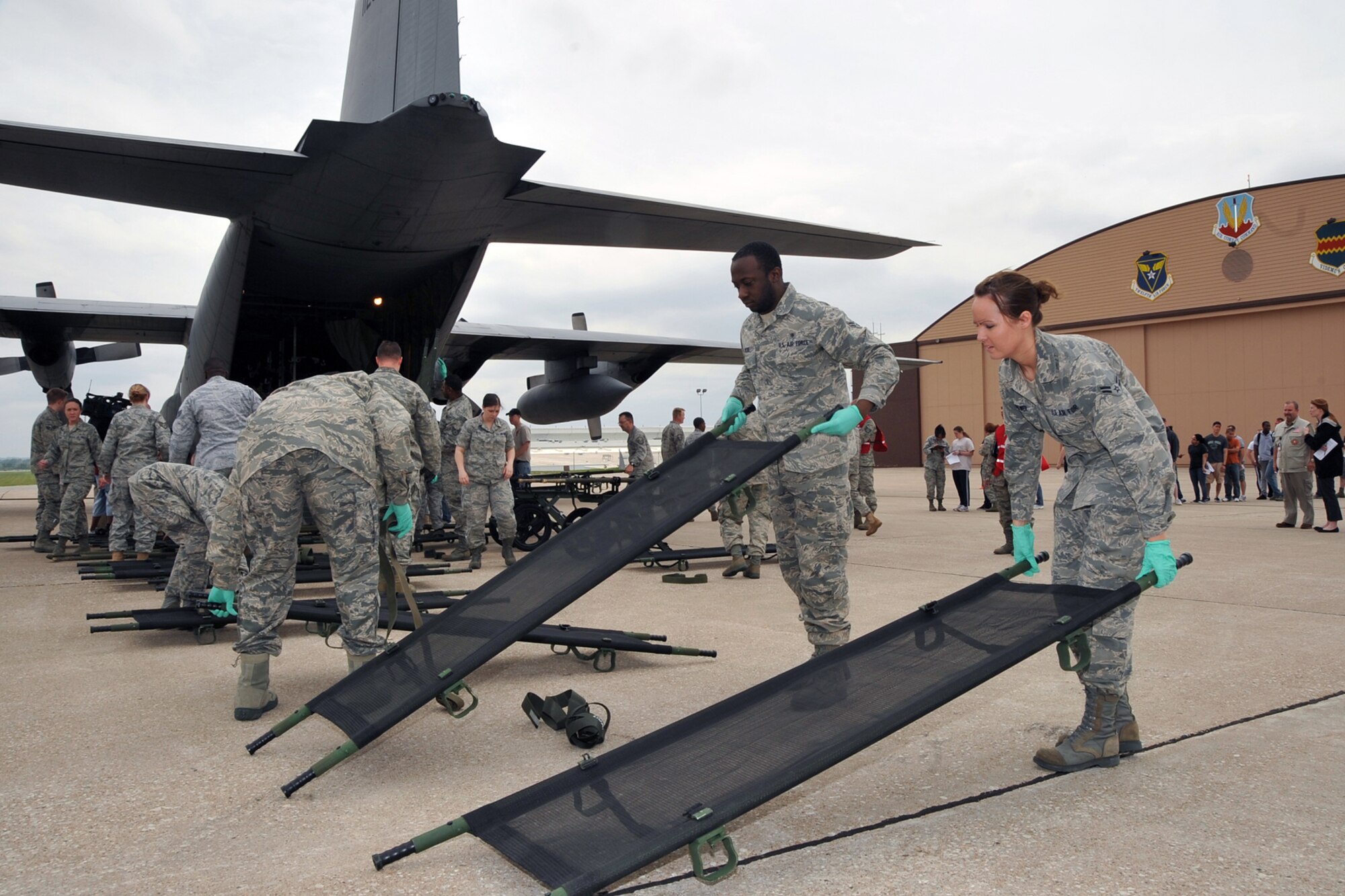 OFFUTT AIR FORCE BASE, Neb. --Medical Group members prepare stretchers for victim transfer onto the aircraft. Offutt Afb performed a national level exercise for 2011 on May 19 at the field house. Many participants were on hand for the NDMS Exercise, including many base agencies from Omaha simulating real life transporting of medical personel and victims acting out and responding giving medical care in case of a community emergency. U.S. Air Force Photo by Jeff W. Gates.