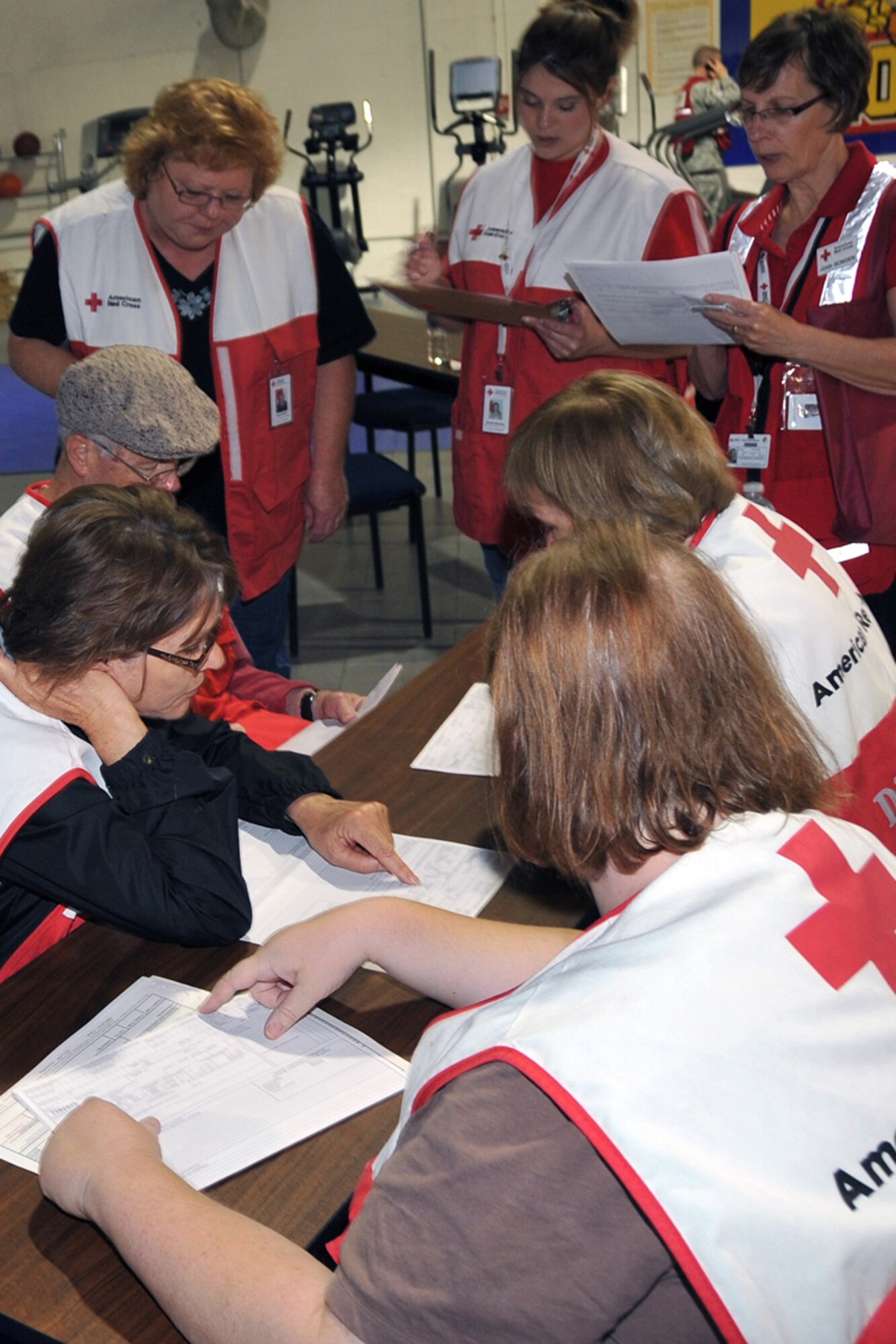 OFFUTT AIR FORCE BASE, Neb. --Members of the American Red Cross go over procedures to participate in the event. Offutt Afb performed a national level exercise for 2011 on May 19 at the field house. Many participants were on hand for the NDMS Exercise, including many base agencies from Omaha simulating real life transporting of medical personel and victims acting out and responding giving medical care in case of a community emergency. U.S. Air Force Photo by Jeff W. Gates.