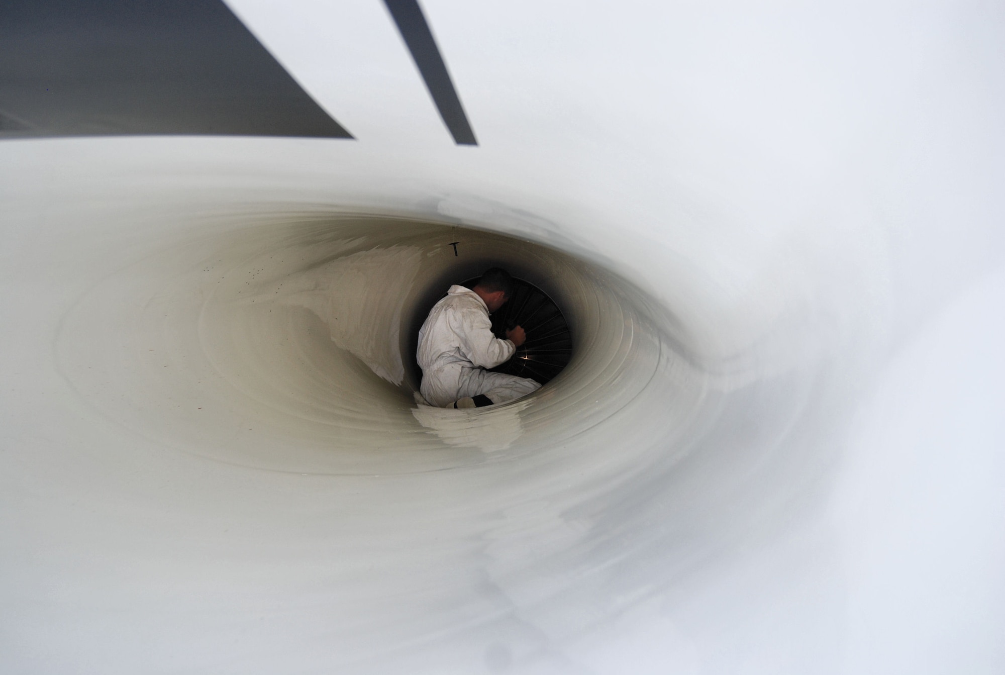 PETERSON AIR FORCE BASE, Colo. –Staff Sgt. Luke Miller, aircraft maintenance for the Air Force Thunderbirds, inspects the air in-take system located under the forward fuselage below the cockpit of one of the Thunderbird’s six F-16s on Peterson Air Force Base, May 23, 2011.  The Thunderbirds landed at Peterson AFB for the U.S. Air Force Academy graduation where they performed a flyover and demonstration as part of the 2011 graduation ceremony, held May 25. (U.S. Air Force photo/Airman 1st Class Jessica Hines) 