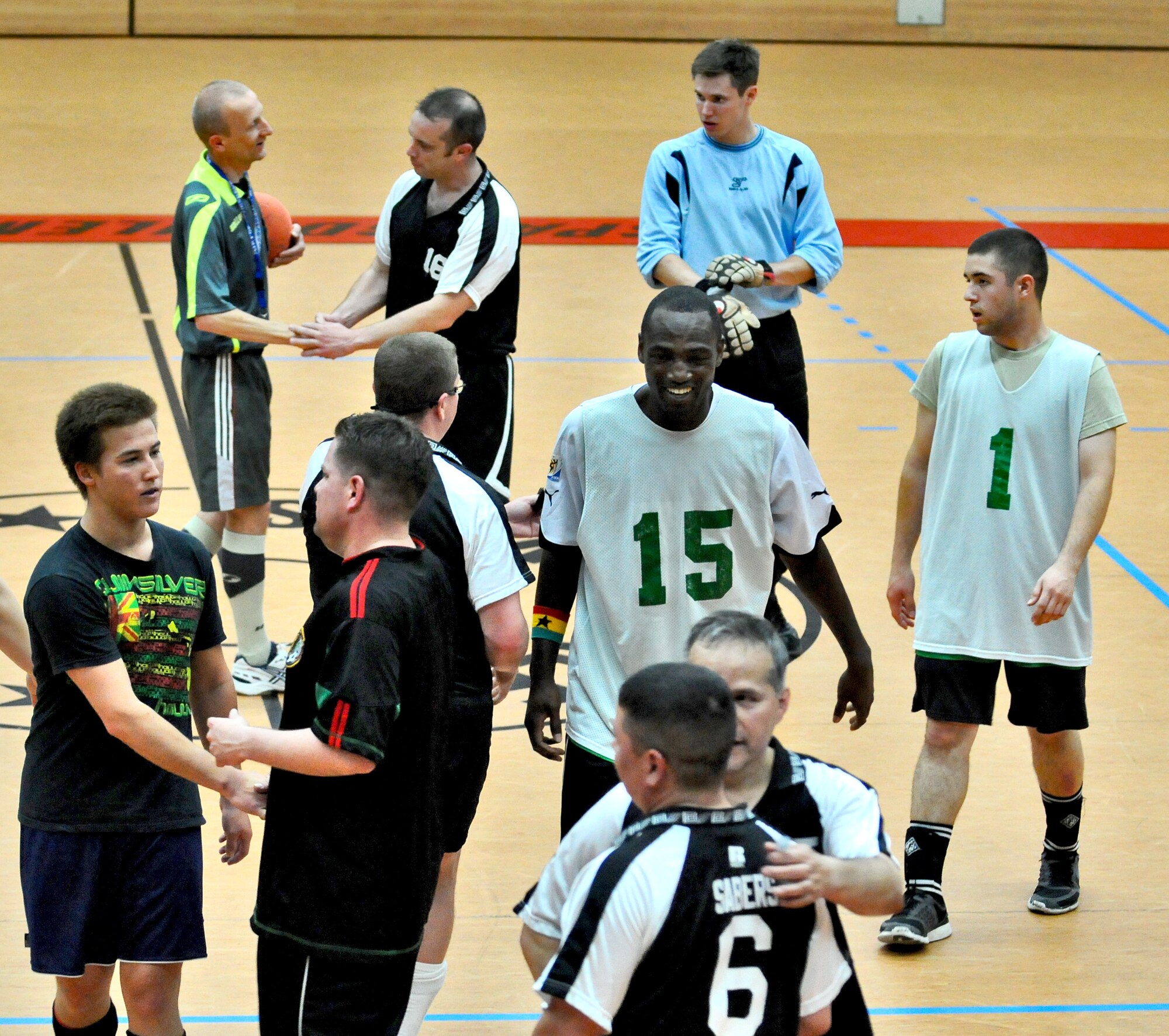 SPANGDAHLEM AIR BASE, Germany – Members from the 52nd Civil Engineer Squadron Force and 52nd Force Support Squadron Sabers shake hands after competing in the 52nd Fighter Wing’s intramural indoor soccer championship game at the Skelton Memorial Fitness Center May 20. The Force defeated the Sabers 9-3 to win the championship.  (U.S. Air Force photo/Senior Airman Nick Wilson)