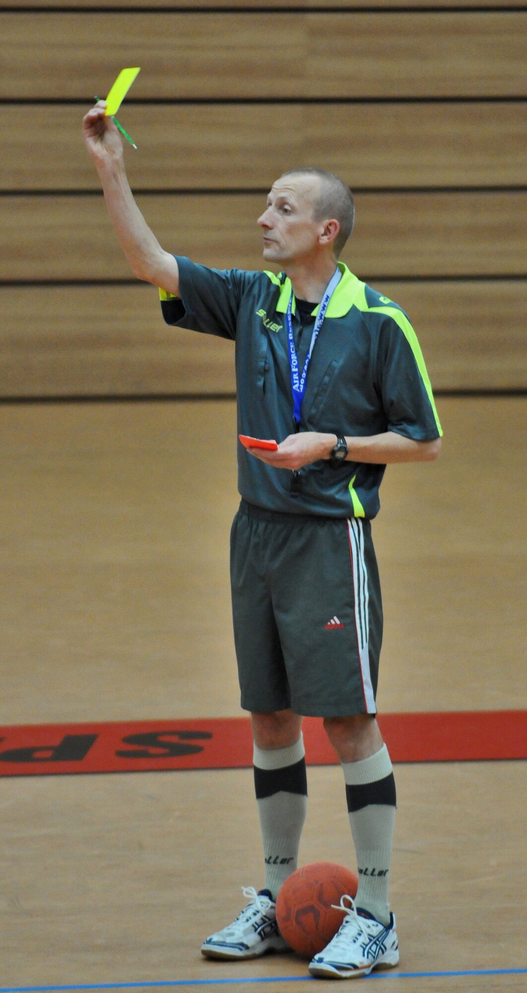 SPANGDAHLEM AIR BASE, Germany – Referee Reiner Godert issues a yellow card to a player during the 52nd Fighter Wing’s intramural indoor soccer championship game at the Skelton Memorial Fitness Center May 20. The 52nd Civil Engineer Squadron Force defeated the 52nd Force Support Squadron Sabers 9-3 to win the championship.  (U.S. Air Force photo/Senior Airman Nick Wilson)