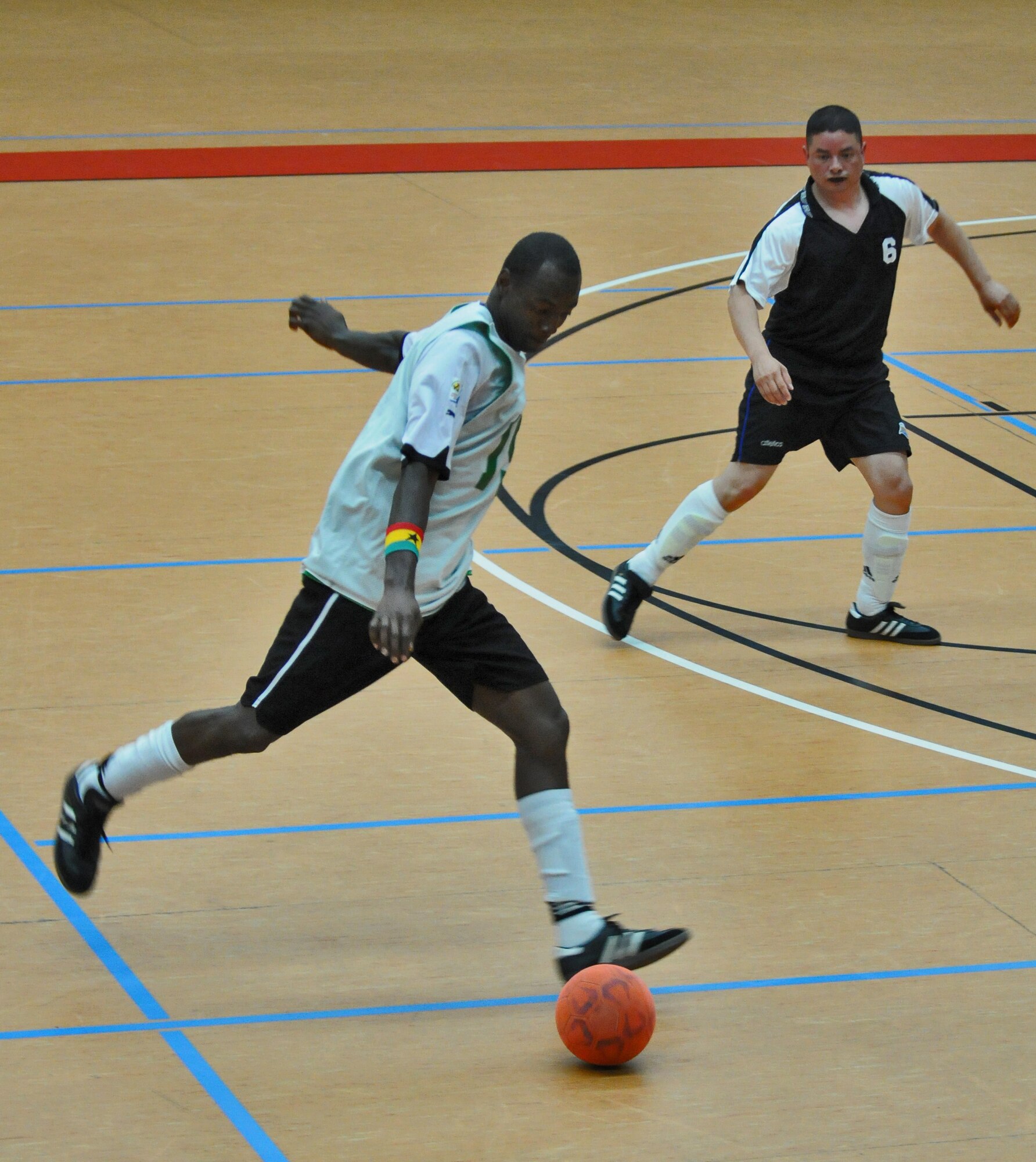 SPANGDAHLEM AIR BASE, Germany – Nana Opoku, 52nd Civil Engineer Squadron Force, prepares to shoot a goal as Ramon Munoznuno, 52nd Force Support Squadron Sabers, defends during the 52nd Fighter Wing’s intramural indoor soccer championship game at the Skelton Memorial Fitness Center May 20. The Force defeated the Sabers 9-3 to win the championship. (U.S. Air Force photo/Senior Airman Nick Wilson)