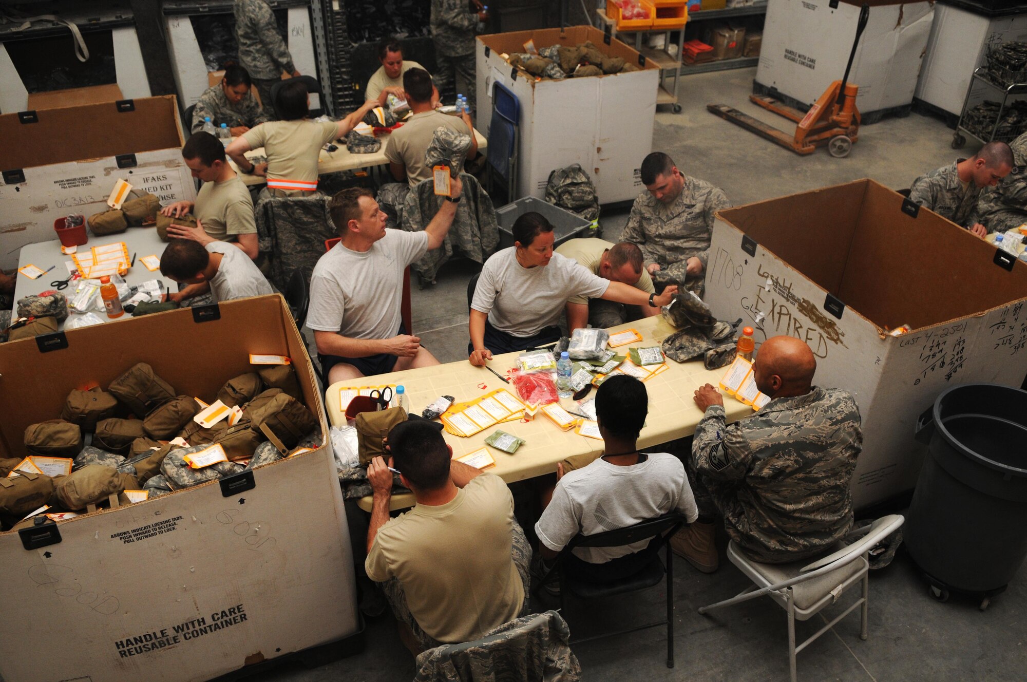 Members from the 379th Air Expeditionary Wing pack Individual First Aid Kit's May 26 in Southwest Asia. The IFAK packing gathers many Airmen and is done all voluntarily.(U.S. Air Force photo/ Staff Sgt. Anthony Graham)