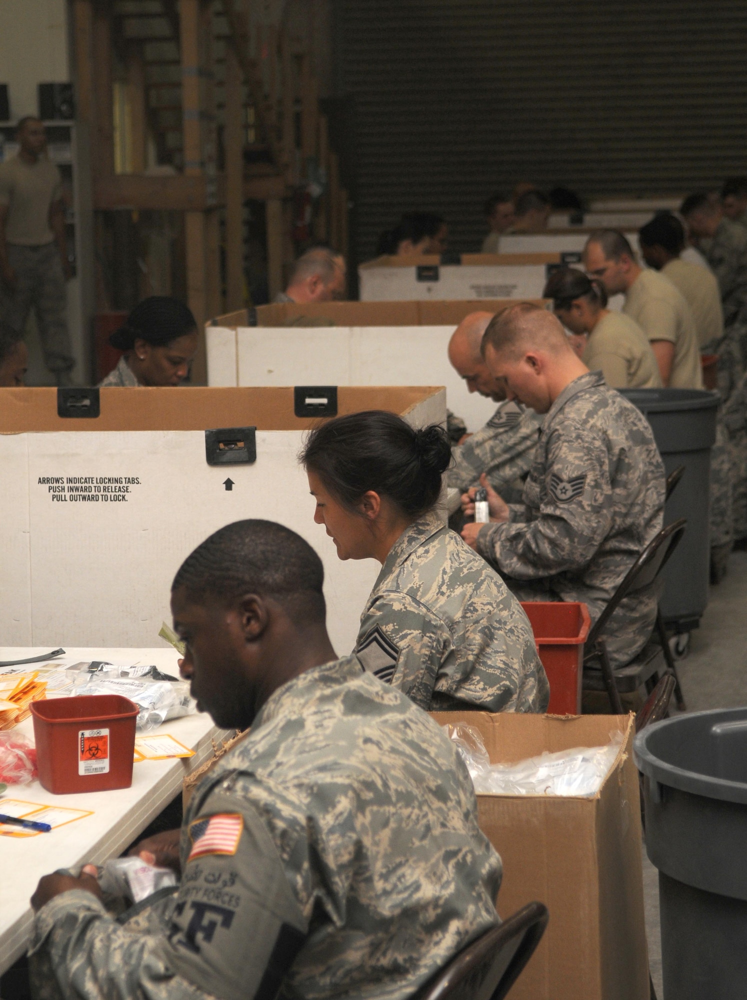 Members from the 379th Air Expeditionary Wing pack Individual First Aid Kit's May 26 in Southwest Asia. The IFAK packing gathers many Airmen and is done on all voluntarily.(U.S. Air Force photo/ Staff Sgt. Anthony Graham)
