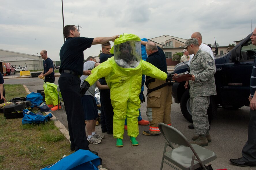 HANSCOM AIR FORCE BASE, Mass. – Tech. Sgt. Jalayne Powers, a bioenvironmental engineering technician, gets assistance with her suit after inspecting suspicious mail delivered to the Hanscom Education and Training Center building May 24. While no hazardous materials were discovered, base personnel are reminded to stay vigilant and report any suspicious activity to security forces. (U.S. Air Force photo by Linda LaBonte Britt)