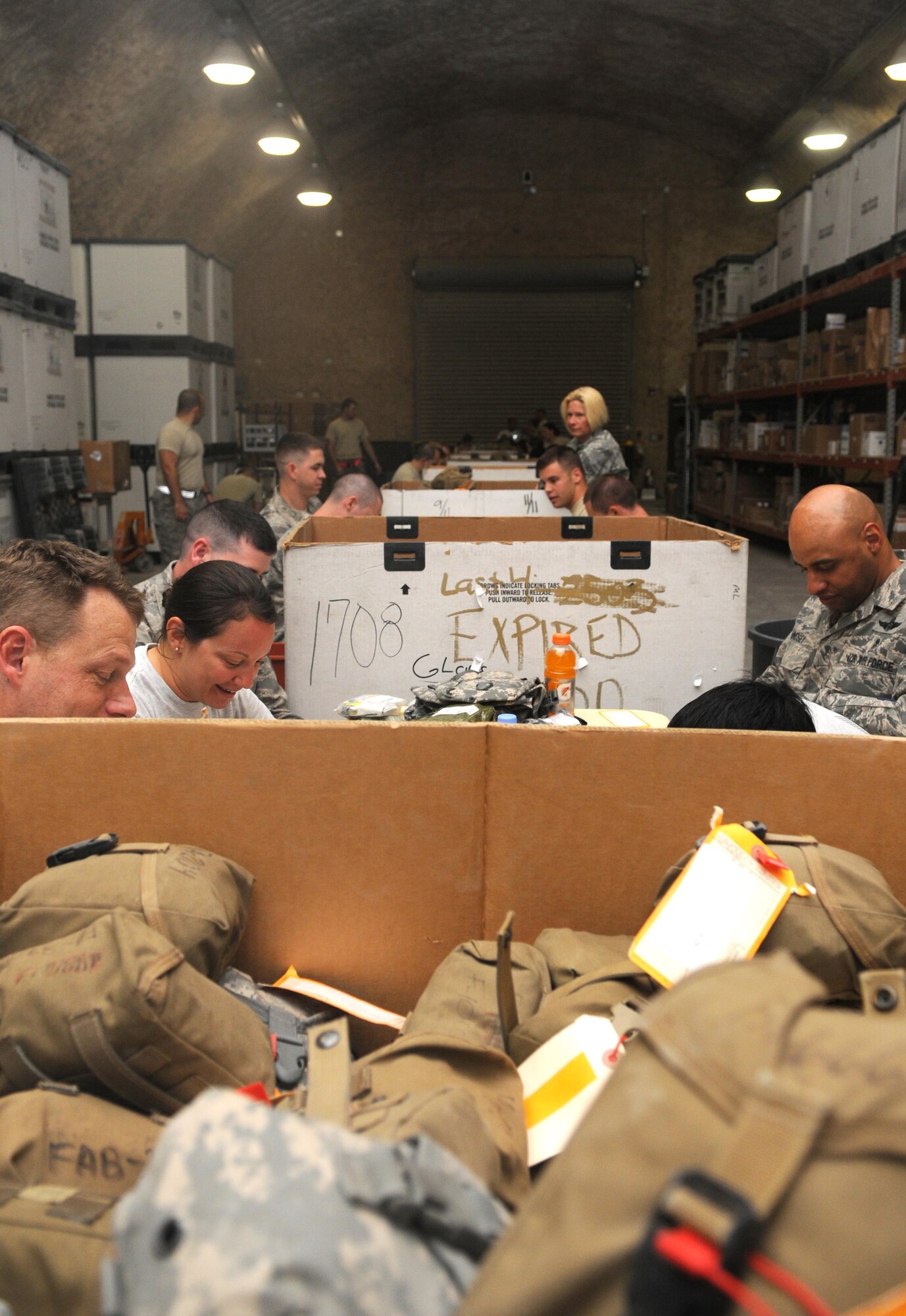 Members from the 379th Air Expeditionary Wing pack Individual First Aid Kit's May 26 in Southwest Asia. The IFAK packing gathers many Airmen and is done all voluntarily.(U.S. Air Force photo/ Staff Sgt. Anthony Graham)