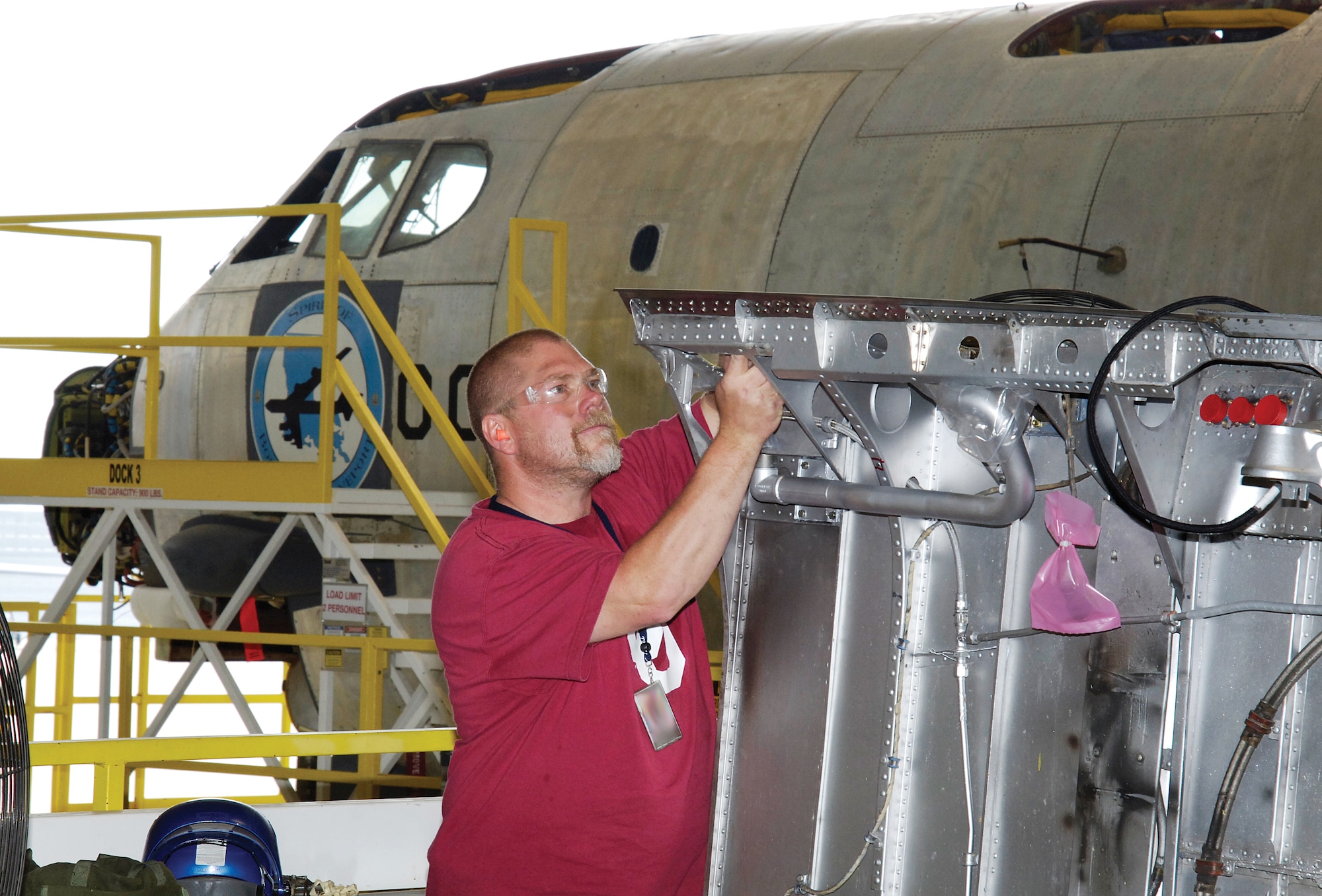 Tinker sheet metal mechanic Mike Willyard works on a B-52’s No. 2 engine strut fireseal doubler May 23 in the bomber’s depot maintenance hangar. (Air Force photo by Margo Wright)