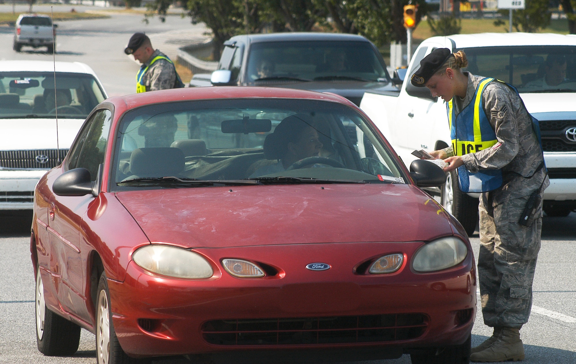 At a random police checkpoint, members of the 78th Security Forces Squadron check for driver's license, registration and proof of insurance. It's part of the unit's Take Back the Road initiative, which is conducted annually just before the 101 Critical Days of Summer safety campaign. U. S. Air Force photo by Sue Sapp