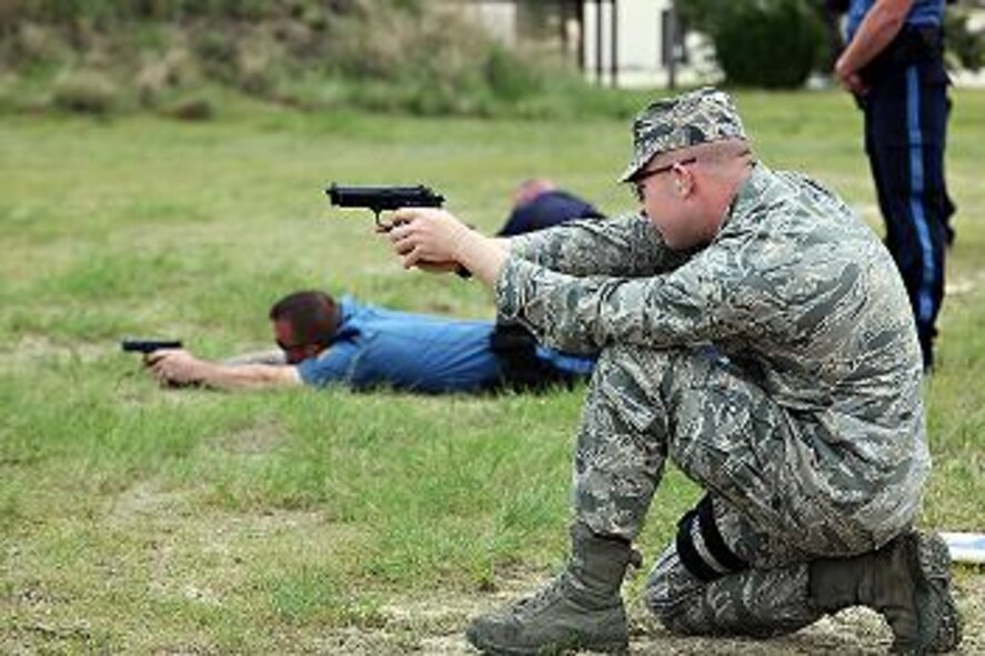 Second Lt. Richard Glover, 87th Security Forces Squadron, takes aim during the team shooting competition in part of National Police Week May 19, 2011, at Joint Base McGuire-Dix-Lakehurst, N.J. The competition was open to the security forces of all branches of the military, local police forces, like Stafford and Barnegat Townships, and the Federal Corrections Institute to engage in friendly comrade. (U.S. Air Force Photo/Wayne Russell)