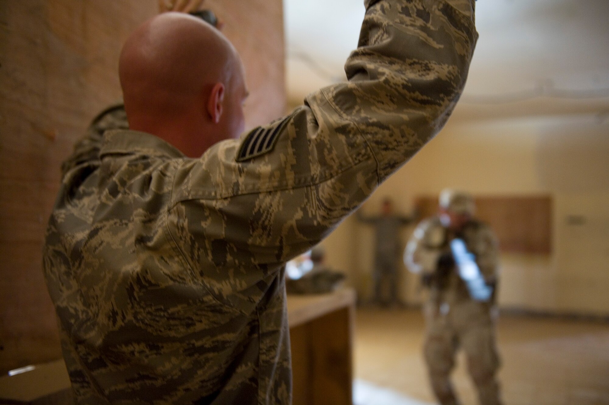 SATHER AIR BASE, Iraq -- A 447th Expeditionary Security Forces Squadron member pretends to be a hostage during urban combat training with Iraqi security forces members May 23. The Iraqi servicemembers were undergoing advanced security forces training to prepare for personal security detail training. (U.S. Air Force photo by Staff Sgt. Levi Riendeau)