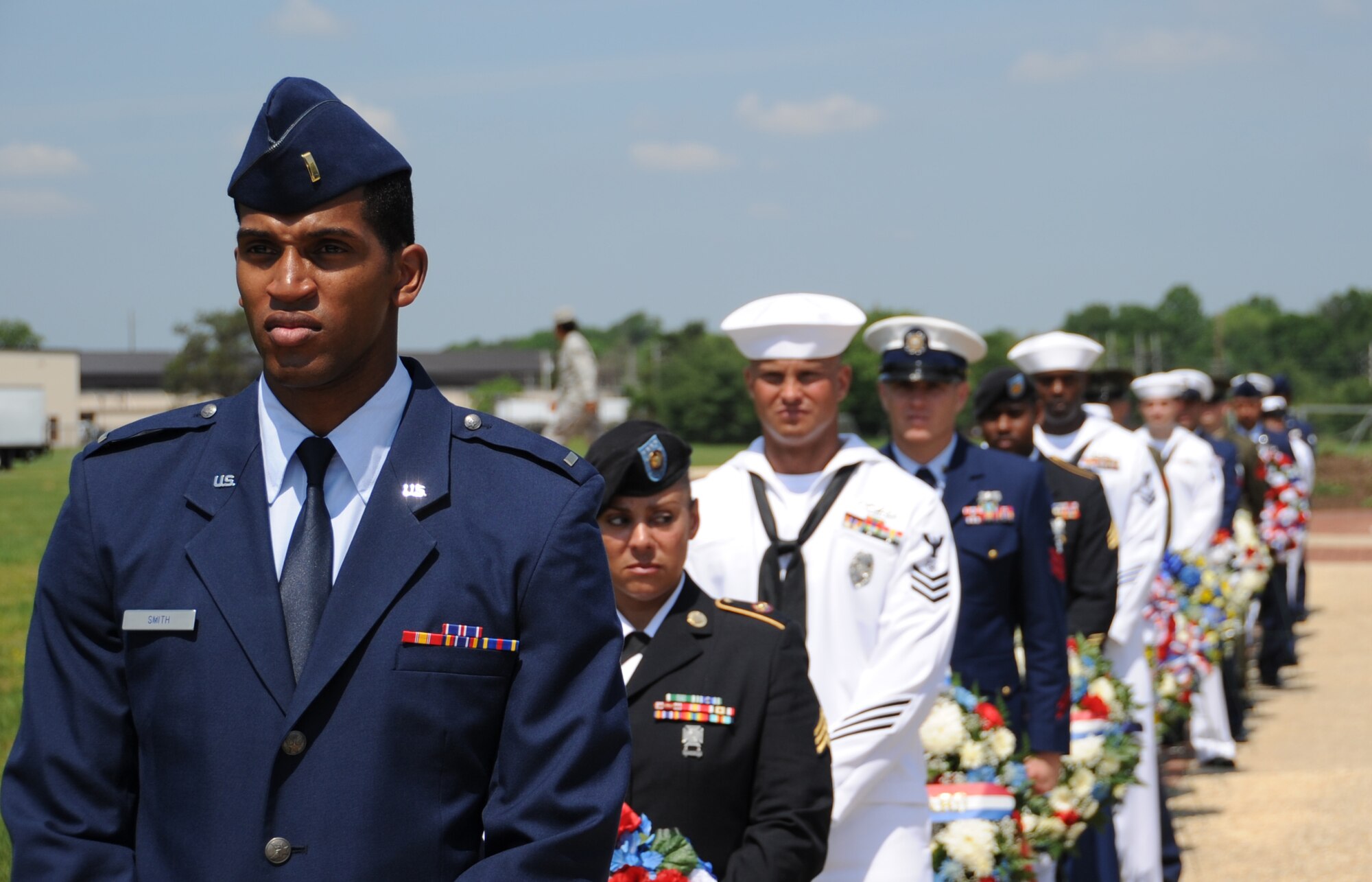 Servicemembers from all branches of the armed forces, retirees, family members and local police officers placed more than 40 wreaths around Pudgy Circle during the Parade of Wreaths ceremony Wednesday at Joint Base McGuire-Dix-Lakehurst. Memorial Day is celebrated across the U.S. in remembrance of all servicemembers who gave the ultimate sacrifice to ensure the freedoms this country has today. (U.S. Air Force photo by Airman 1st Class Dennis Sloan/Released)