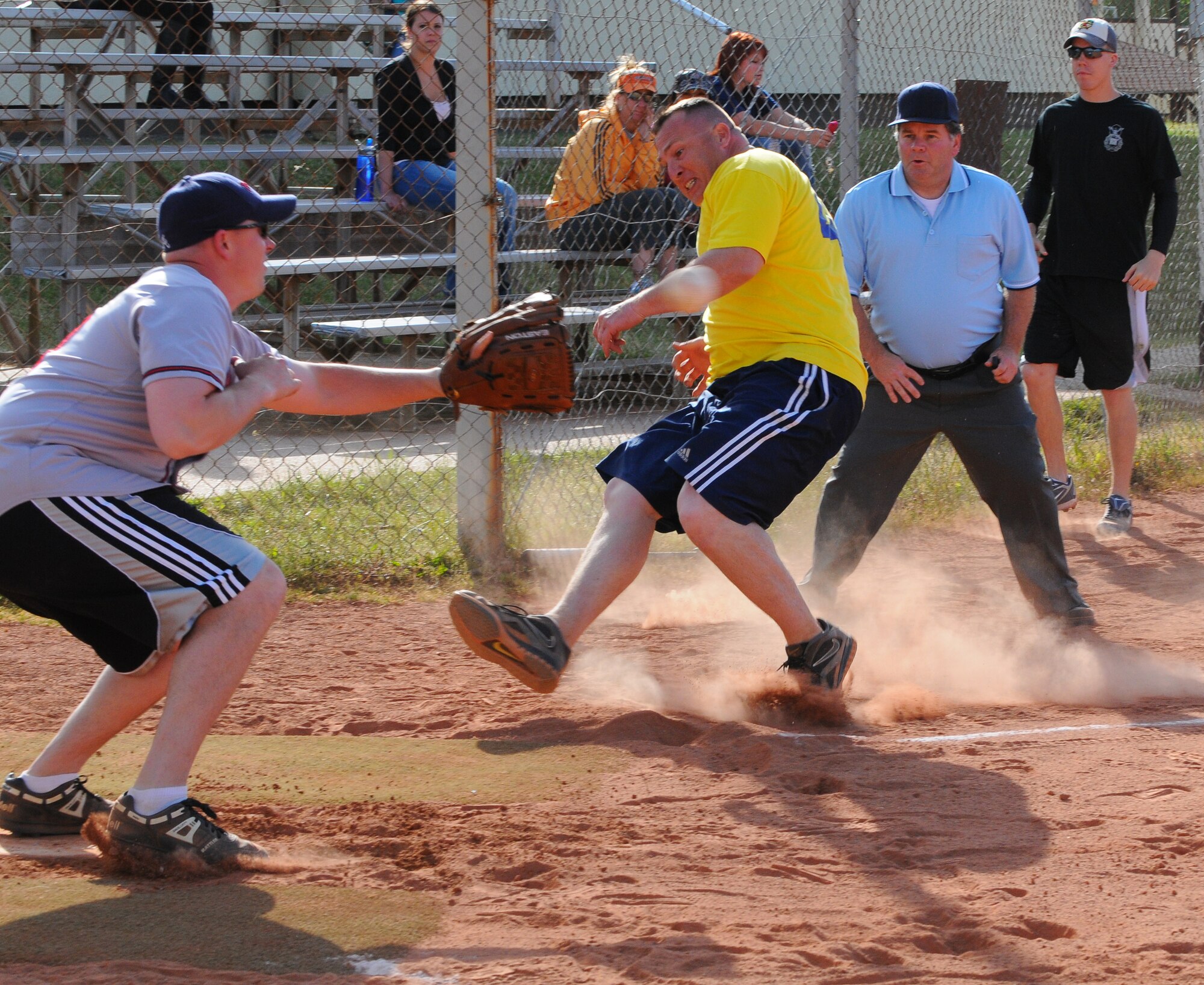 SPANGDAHLEM AIR BASE, Germany – Matthew Barrey, 52nd Security Forces Squadron, slides home as John Ferguson, 52nd Logistics Readiness Squadron, attempts to catch the softball to tag him out during an intramural softball game here May 24. The 52nd LRS defeated the 52nd SFS 10-8. The intramural softball league began May 23 and runs into August 2011. (U.S. Air Force photo/Airman 1st Class Dillon Davis)