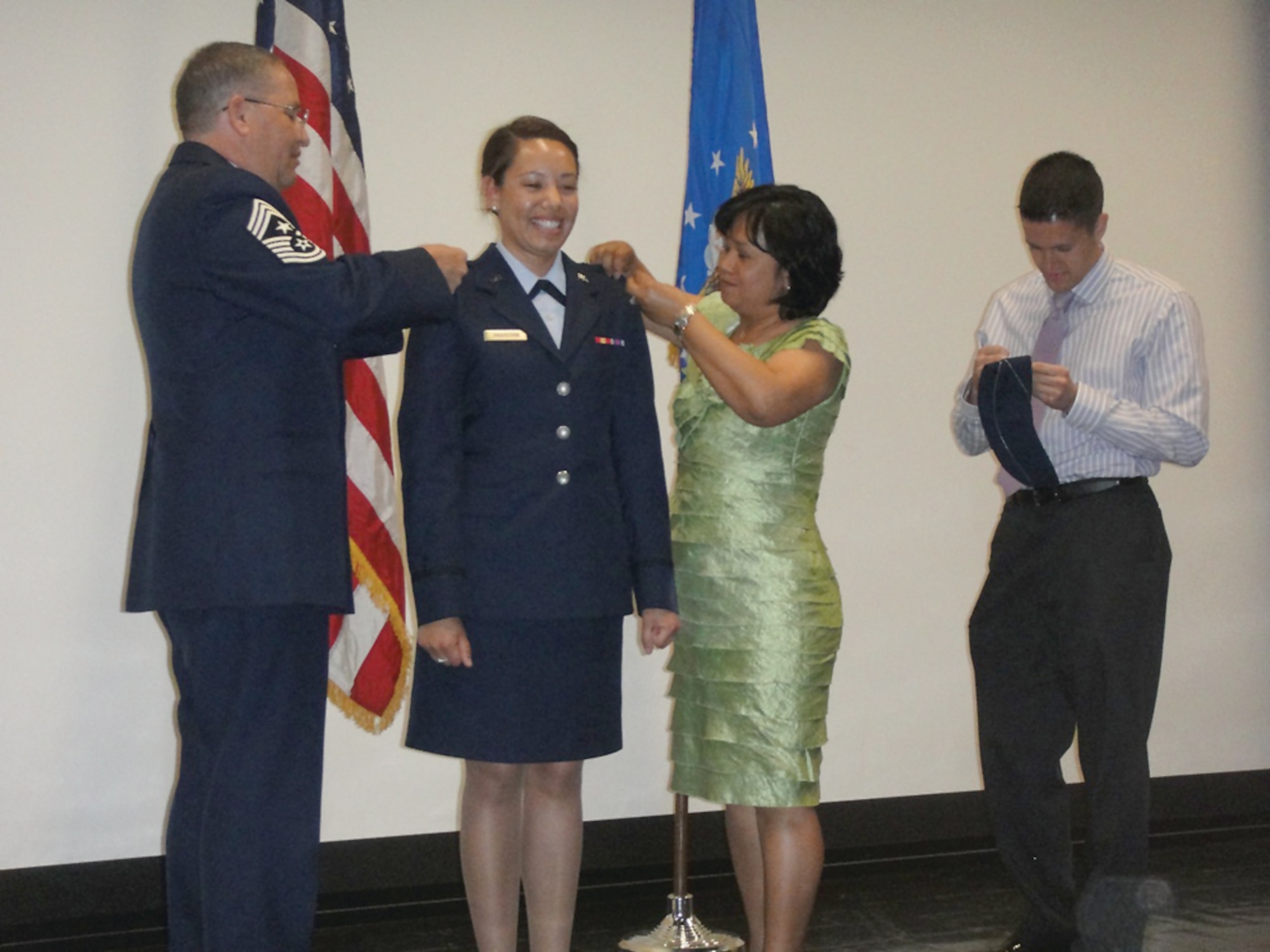 65th Air Base Wing Command Chief Samuel Hagadorn and his wife, Loida, pin second lieutenant bars on daughter Shannon Hagadorn at an AFROTC commissioning ceremony May 14 at the University of Arizona in Tucson.  (Courtesy photo)