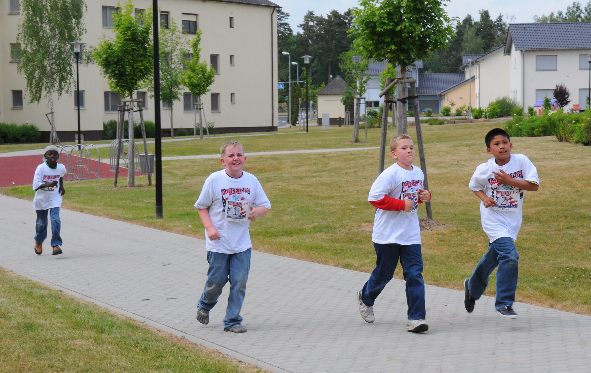 SPANGDAHLEM AIR BASE, Germany – Children from Spangdahlem Elementary School and Spangdahlem Middle School run through the base housing courtyard during the Armed Forces Kids’ Run here May 20. The Armed Forces Kids’ Run happens every year in May and includes military children in Germany, the U.S., Bahrain, Greece, Puerto Rico, Japan, Iceland, England and Italy. (U.S. Air Force photo/Airman 1st Class Dillon Davis)