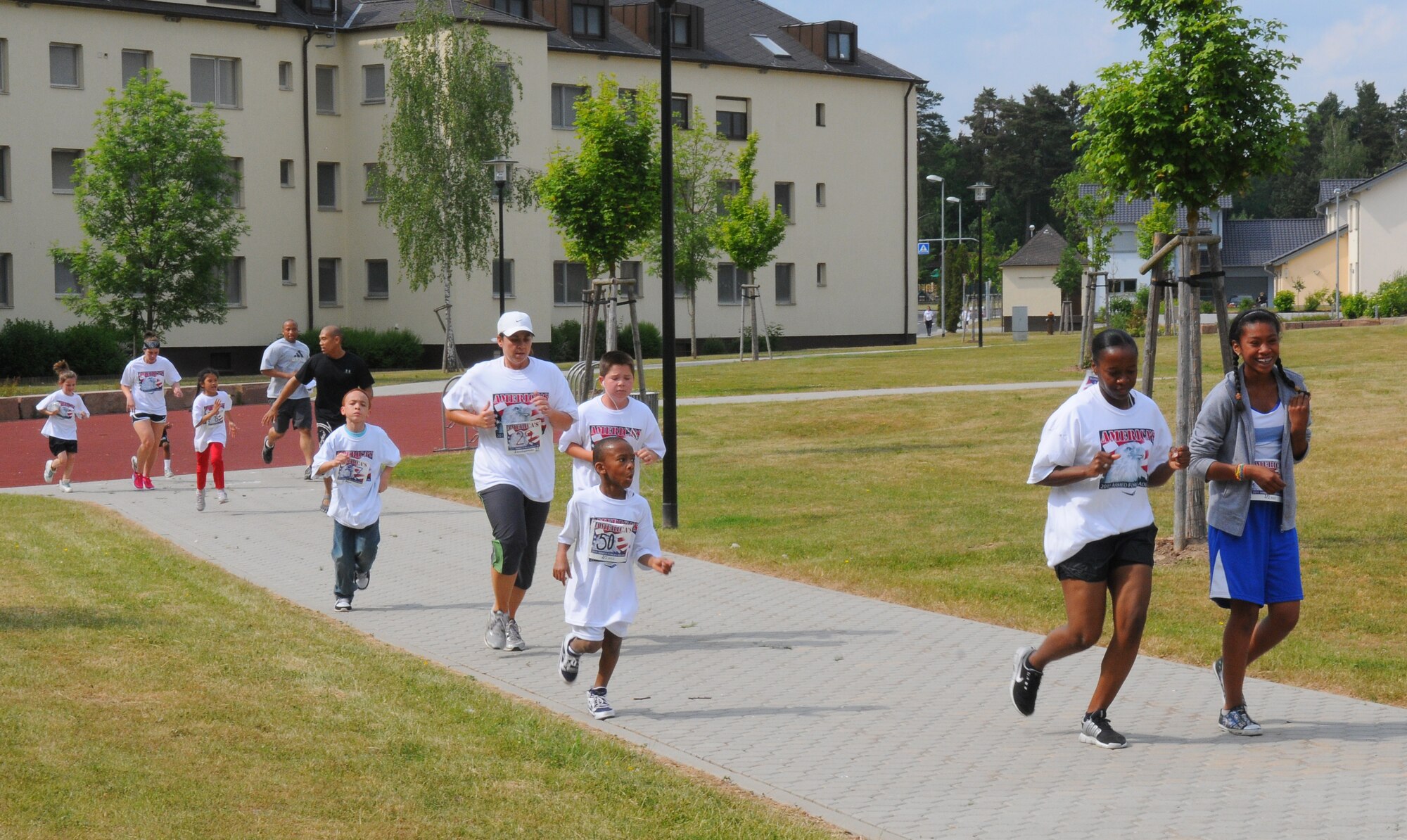 SPANGDAHLEM AIR BASE, Germany – Children from Spangdahlem Elementary School and Spangdahlem Middle School run through the base housing courtyard during the Armed Forces Kids’ Run here May 20. The Armed Forces Kids’ Run happens every year in May and includes military children in Germany, the U.S., Bahrain, Greece, Puerto Rico, Japan, Iceland, England and Italy. (U.S. Air Force photo/Airman 1st Class Dillon Davis)