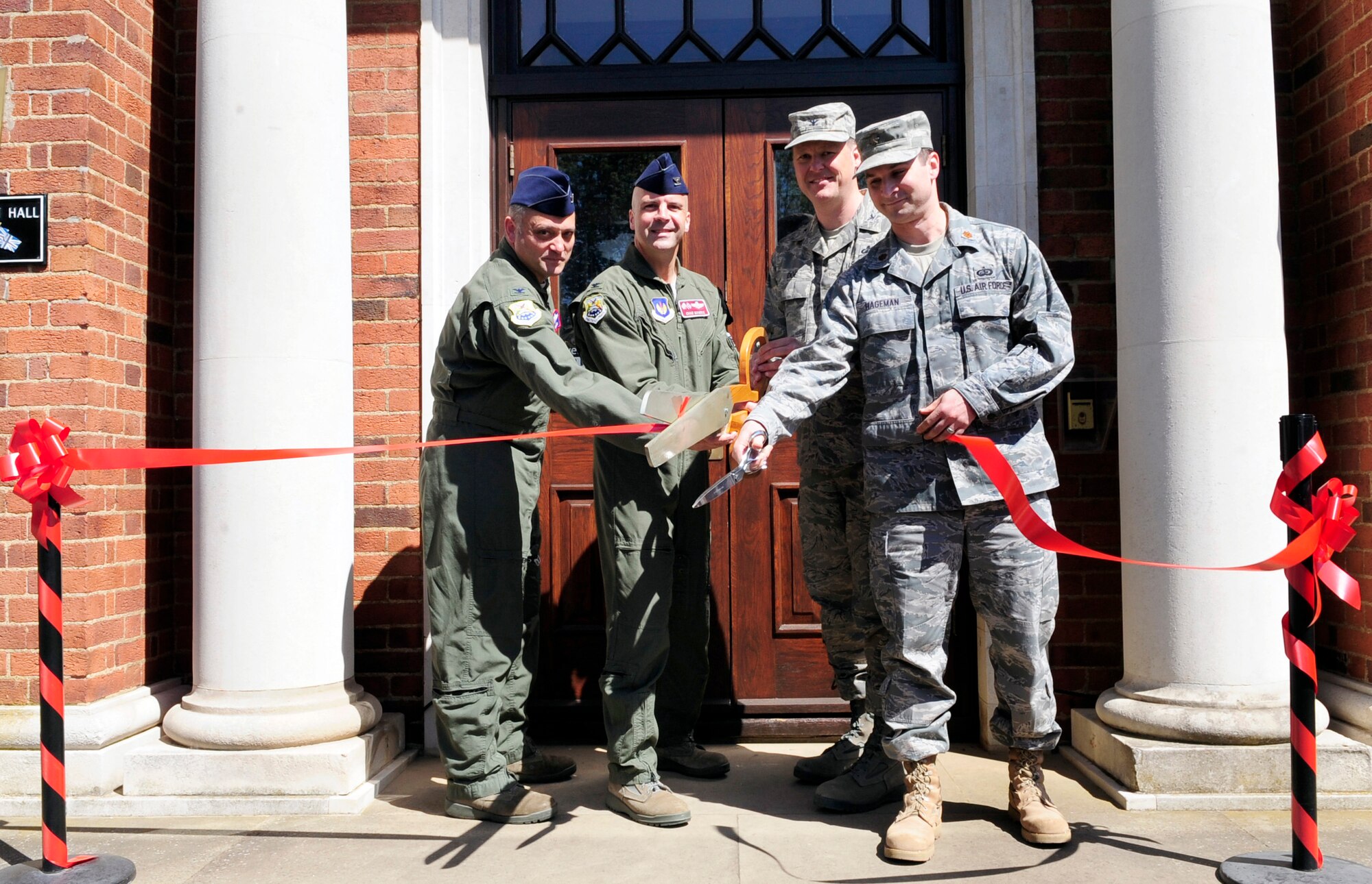 RAF MILDENHALL, England -- Col. Michael Winters, 100th Air Refueling Wing vice commander, Col. Chad Manske, 100th ARW commander, Col. David Doe, 100th Mission Support Group commander, and Maj. Adrian Hageman, 100th Force Support Squadron commander, host Middleton Hall's reopening here May 25, 2011. A ribbon cutting was held after a 17-month closure for the $650,000 renovation project. (U.S. Air Force photo/Senior Airman Ethan Morgan)