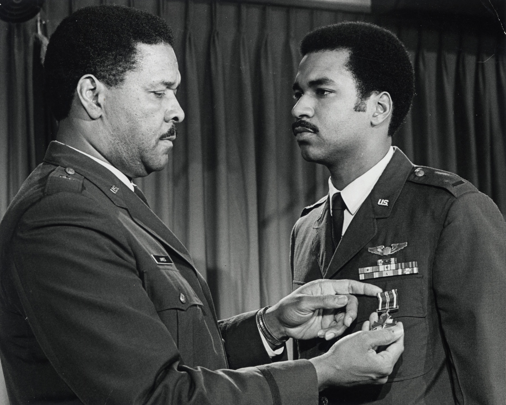 Lt. Daniel James III receives the first of his two Distinguished Flying Crosses from his father, Brig. Gen. Daniel "Chappie" James Jr. The younger James served two combat tours in Southeast Asia. (U.S. Air Force photo)