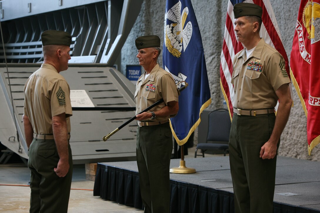 Sgt. Maj. Courtney Curtis, Maj. Gen. Rex McMillian and Sgt. Maj. Paul Anderson stand ready to perform the relief and appointment ceremony at the World War II Museum, May 26.  Sgt. Maj. Courtney Curtis took over for Sgt. Maj. Paul Anderson as the 4th MAW Sergeant Major.