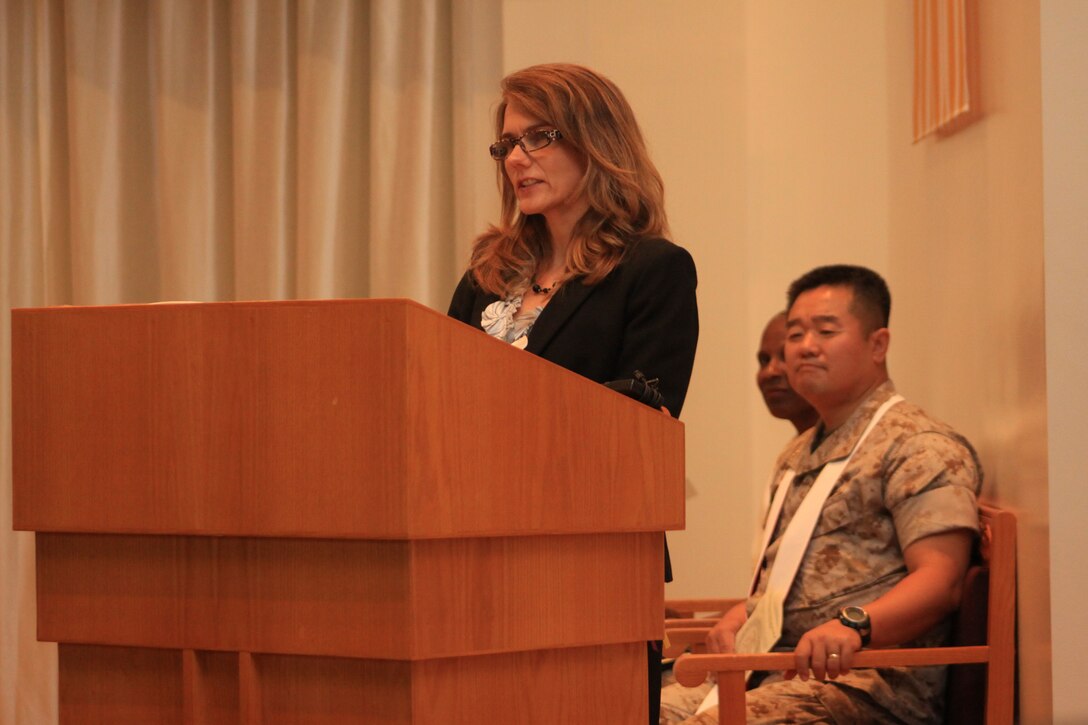Maryann West, wife of Lt. j.g. Bruce B. West, delivered one of the eulogies to a crowd of saddened community residents during West’s memorial service at the Marine Memorial Chapel here May 26. Throughout West’s eulogy, friends and loved ones shared a common trend on the things they will remember most about him, his devotion to serving others, his contagious positive attitude and his permanent genuine smile.
