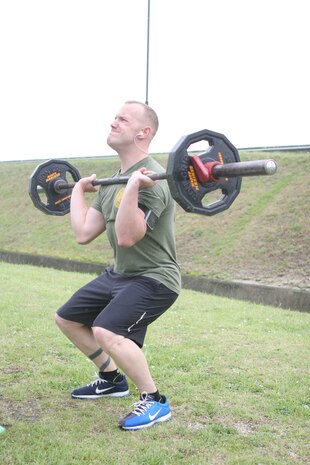 Jason N. Nickell prepares to hoist the weight overhead during the Fitness Fallout here May 27. Nickell took third place in the men’s division. Nine participants took part in the event. Adrian R. Figueora took first place in the men’s division and Tiffany L. Hernandez placed first in the women’s division.