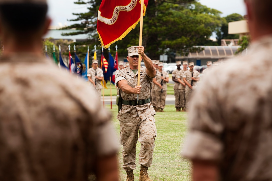Sgt. Maj. Andrew Cece, battalion sergeant major, 3rd Battalion, 3rd Marine Regiment, carries the battalion battle colors toward Lt. Col. Jeffrey C. Holt, outgoing commanding officer, 3/3, during a change of command ceremony at Dewey Square on Marine Corps Base Hawaii, May 26, 2011. Holt, who assumed command of 3/3 in 2009, led the battalion on a deployment to Helmand province, Afghanistan, in support of Operation Enduring Freedom in 2010. He received a Bronze Star Medal with gold star in lieu of second award for his leadership during the deployment. He relinquished command to Lt. Col. Matthew J. Palma, who began his career as a platoon commander with 3/3 in 1996, and most recently served as a planner with G-5, U.S. Marine Corps Forces, Pacific.