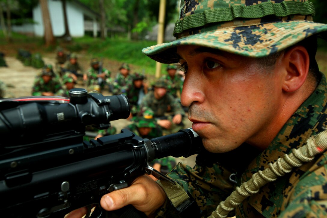 Lance Cpl. Alfred Castaneda, a rifleman from 3rd Platoon, Landing Force Company, demonstrates close combat techniques during military operations on urban terrain training with Marines from 6th Battalion, 2nd Brigade, Korps Marinir. Landing Force Company, comprised primarily of Marines from 2nd Battalion, 23rd Marine Regiment and 4th Assault Amphibian Battalion, 4th Marine Division, is participating in Cooperation Afloat Readiness and Training (CARAT) 2011. CARAT is an annual series of bilateral exercises held between the U.S. and Southeast Asian nations with the goals of enhancing regional cooperation, promoting mutual trust and understanding, and increasing operational readiness.  While in Indonesia, the service members from both nations will train together on martial arts, military operations on urban terrain, jungle warfare, combat marksmanship and combat lifesaving. (U.S. Marine Corps Photo by Cpl. Aaron Hostutler)