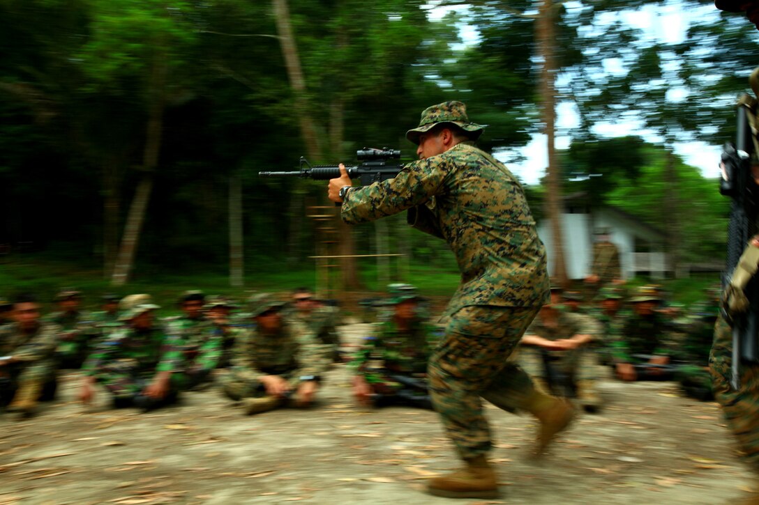 Lance Cpl. Alfred Castaneda, a rifleman from 3rd Platoon, Landing Force Company, demonstrates close combat techniques during military operations on urban terrain training with Marines from 6th Battalion, 2nd Brigade, Korps Marinir. Landing Force Company, comprised primarily of Marines from 2nd Battalion, 23rd Marine Regiment and 4th Assault Amphibian Battalion, 4th Marine Division, is participating in Cooperation Afloat Readiness and Training (CARAT) 2011. CARAT is an annual series of bilateral exercises held between the U.S. and Southeast Asian nations with the goals of enhancing regional cooperation, promoting mutual trust and understanding, and increasing operational readiness.  While in Indonesia, the service members from both nations will train together on martial arts, military operations on urban terrain, jungle warfare, combat marksmanship and combat lifesaving. (U.S. Marine Corps Photo by Cpl. Aaron Hostutler)