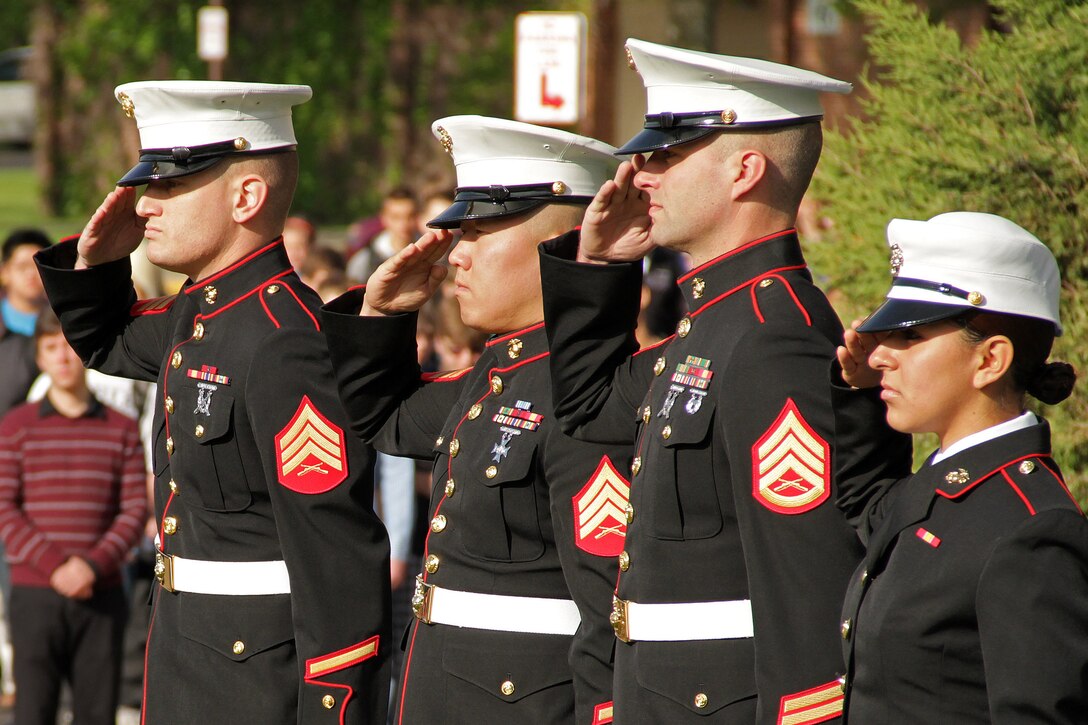 Faculty and students from Hudson High School watch four Marines with Recruiting Substation Woodbury salute the Colors during the Empty Parking Lot Project ceremony May 27, an event dedicated to honoring all service members, past and present. To show their appreciation and recognize the sacrifices made by men and women serving at home and abroad, students emptied the school's parking lot by walking, riding bikes or taking the bus to school. For additional imagery from the event, visit www.facebook.com/rstwincities.