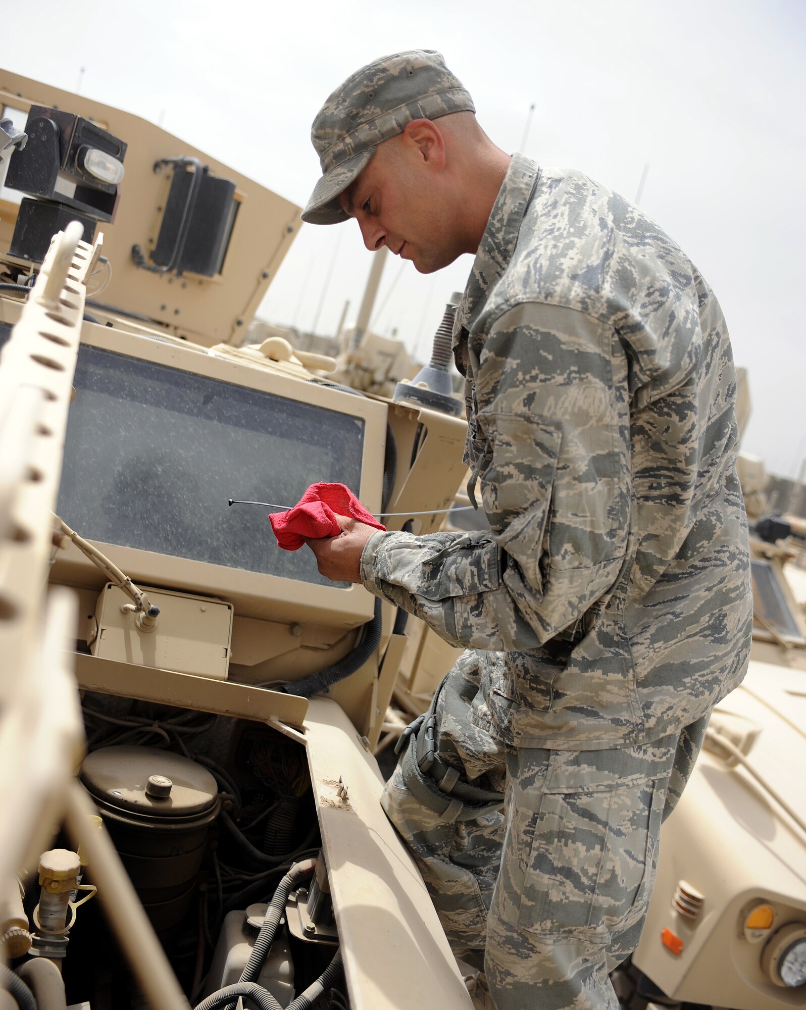 Tech Sgt. Brian Henry checks the oil in a mine resistant ambush protected all-terrain vehicle May 25, 2011, at Kandahar Airfield, Afghanistan. Sergeant Henry is in charge of maintaining about a dozen vehicles similar to the M-ATV in use by explosive ordinance disposal personnel.  Sergeant Henry is a vehicle mechanic assigned to the 466th Explosive Ordinance Disposal Bravo Squadron. (U.S. Air Force photo by Senior Airman Willard E. Grande II)