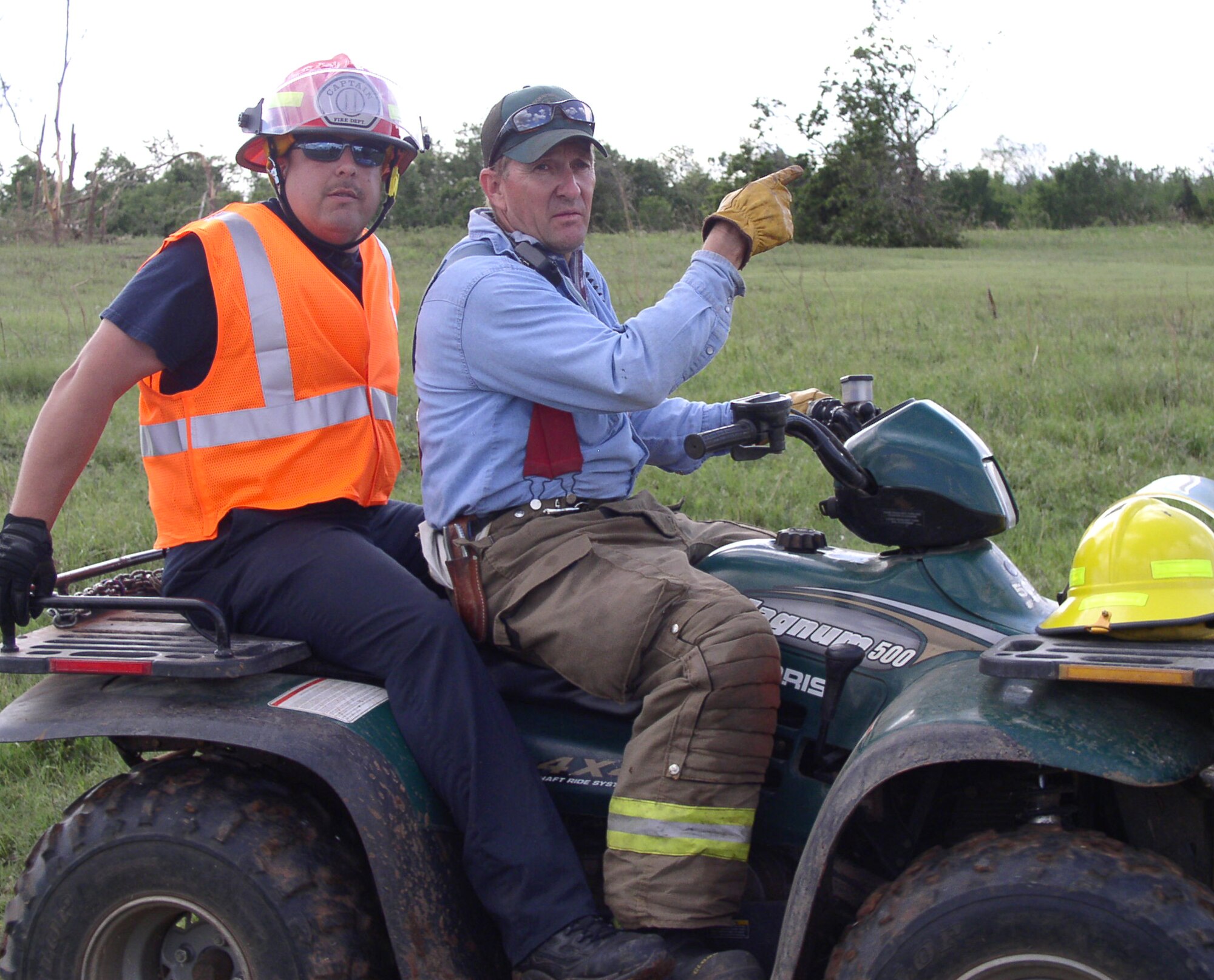 Brad Phillips, left, a Vance firefighter, and Curtis Toewes, a Hillsdale, Okla., volunteer firefighter, search for a missing 3-year-boy May 25 in the tornado ravaged Piedmont area west of Oklahoma City. (Courtesy photo)