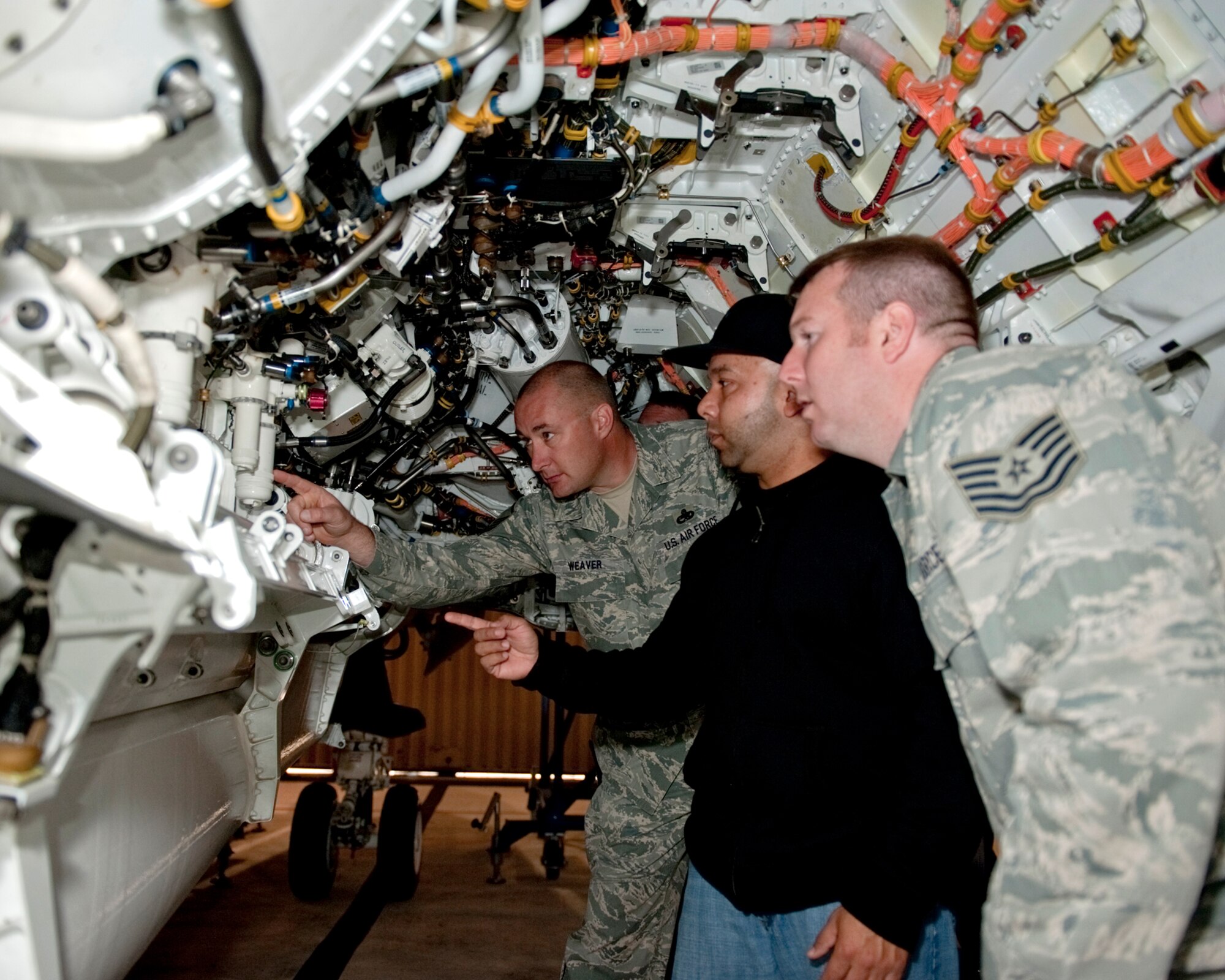 Master Sgt. Timothy Weaver (rear) and Tech. Sgt. Lucas Delk work with Pedro Vera inside the internal weapons bay of an F-35C Lightning II at Naval Air Station Patuxent River, Md.  The two NCOs are crew chiefs from the 33rd Fighter Wing at Eglin Air Force Base, Fla.  Mr. Vera is a Lockheed Martin Airframe Powerplant Group technician. (Courtesy photo)