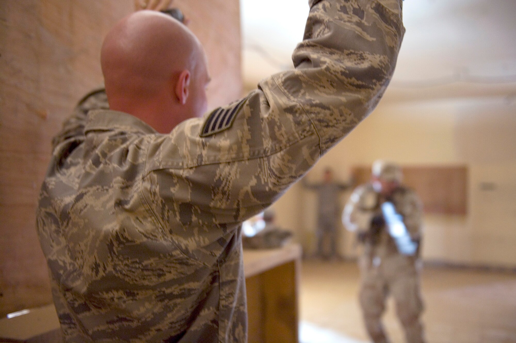 A 447th Expeditionary Security Forces Squadron member pretends to be a hostage during urban combat training with Iraqi security forces members May 23, 2011, at Sather Air Base, Iraq. The Iraqi service members were undergoing advanced security forces training to prepare for personal security detail training. (U.S. Air Force photo/Staff Sgt. Levi Riendeau)
