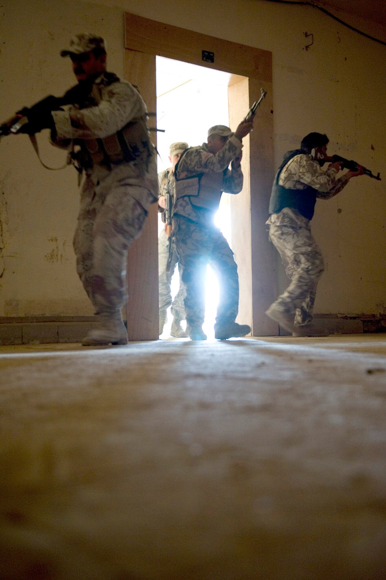 Iraqi security forces members storm a room during advanced security forces training May 23, 2011, at Sather Air Base, Iraq. Air Force trainers with the 447th Expeditionary Security Forces Squadron taught Iraqi service members advanced security forces tactics to prepare them for personal security detail training. (U.S. Air Force photo/Staff Sgt. Levi Riendeau)