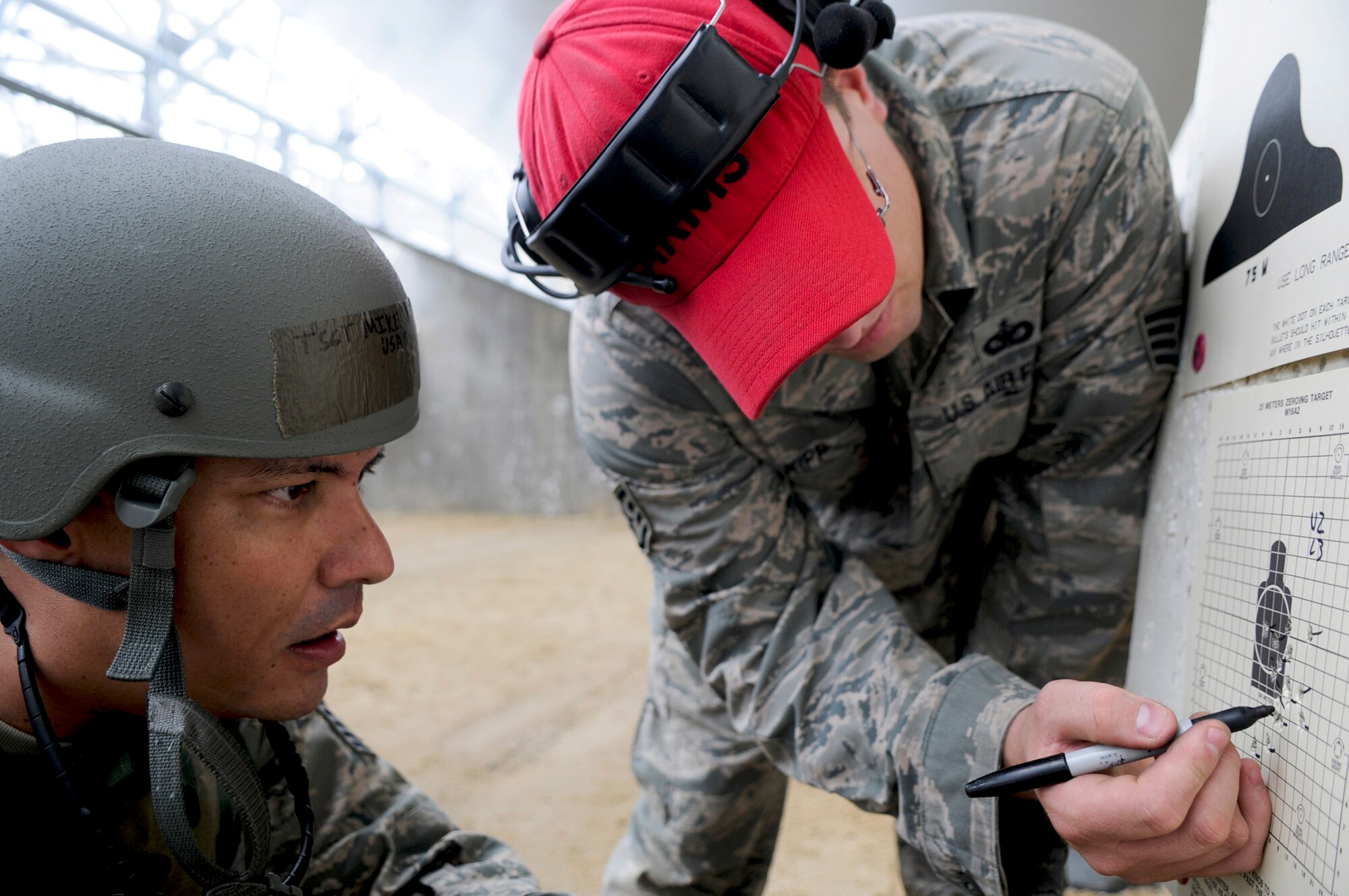 Tech. Sgt. Michael Tateishi  watches as Staff Sgt. James Kipp indicates sight corrections on a zeroing target May 24, 2011, at the combat arms firing range at Kadena Air Base, Japan. Renovations began due to the dangerous conditions at the former combat arms area. Sergeant Tateishi is the 18th Wing Public Affairs chief of operations, and Sergeant Kipp is an 18th Security Forces combat arms instructor. (U.S. Air Force photo/Airman 1st Class Maeson L. Elleman) 