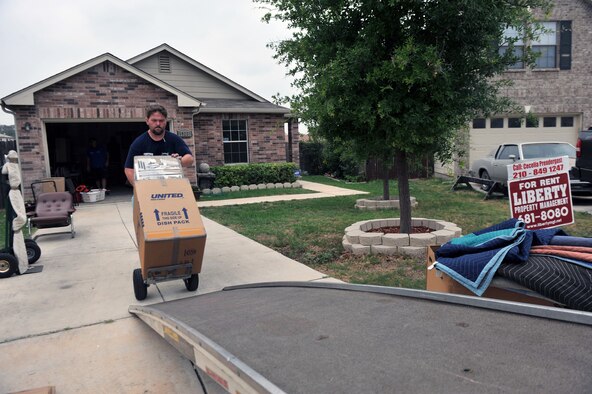 Eddie Goodman pushes a dolly full of boxes as he packs up Staff Sgt. Nick Kurtz's household goods to Fort George G. Meade, Md., on May 24, 2011. Kurtz is a broadcast journalist attached to Defense Media Activity. Goodman works for Central United. Peak season for household goods movement due to PCS is May 15 to July 30. (U.S. Air Force photo/Staff Sgt. Desiree N. Palacios)