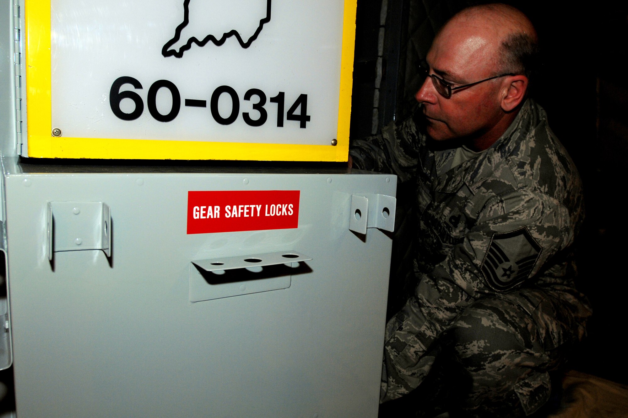 GRISSOM AIR RESERVE BASE, Ind. -- Master Sgt. Stephen Edington, a crew chief with the 434th Aircraft Maintenance Squadron, aligns a storage container on aircraft 60-0314. The aircraft went through an extensive restoration and refurbishment process recently. (U.S. Air Force photo/Tech. Sgt. Douglas Hays)