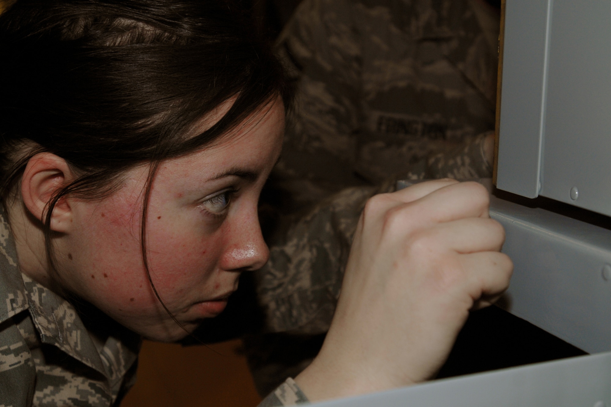 GRISSOM AIR RESERVE BASE, Ind. -- Senior Airman Alina Biesenbach, crew chief with the 434th Aircraft Maintenance Squadron, mounts a storage bin inside aircraft 60-0314, as they put the finishing touches on a restoration of the aircraft. (U.S. Air Force photo/Tech. Sgt. Douglas Hays)