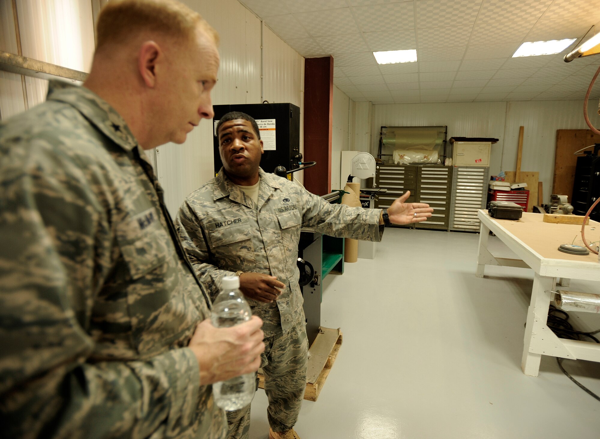 CAMP TAJI, Iraq -- Tech. Sgt. Derrick Hatcher, right, sheet metal advisor for Iraq Training and Advisory Mission - Air, showcases the new metals technology and sheet metal shop to Brig. Gen. Robert McMurry Jr., Iraq Security Assistance Mission director, during a visit with 721st Air Expeditionary Advisory Squadron officials April 27. Sergeant Hatcher is deployed from Luke Air Force Base, Ariz., and hails from Central Islip, N.Y. (U.S. Air Force/Tech. Sgt. Jason Lake)