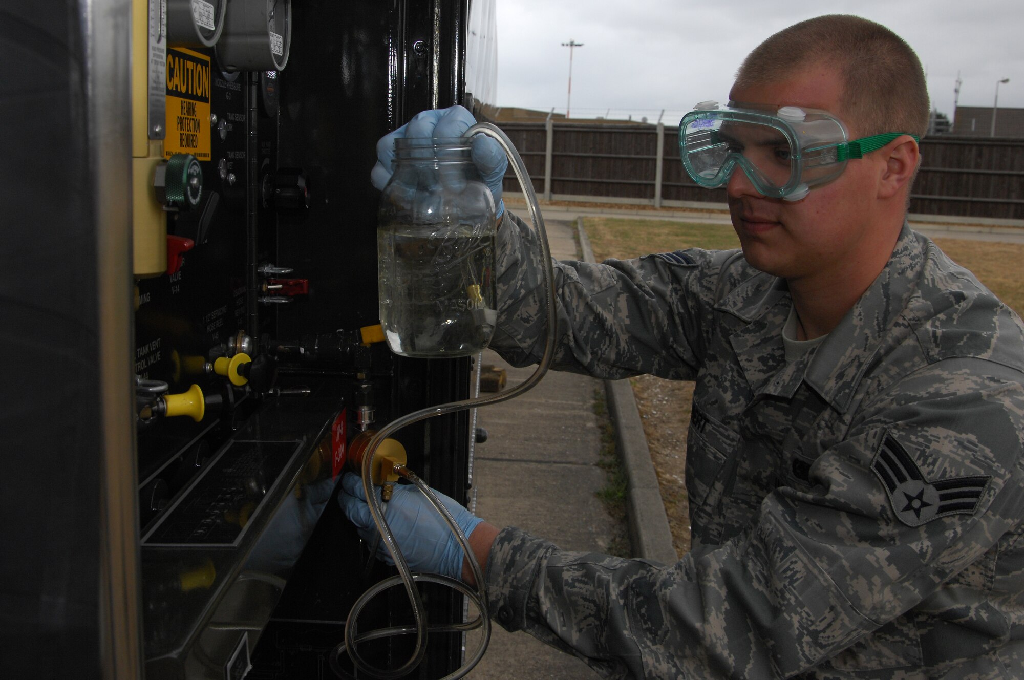 ROYAL AIR FORCE LAKENHEATH, England-- Senior Airman Justin Gilbert, 48th Logistics Readiness Squadron Fuels Laboratory technician, collects fuel for testing from a R-11 refueling unit on May 26, 2011. Airman Gilbert was nominated for a Liberty Spottlight because he displays the core value of 'Excellence in All We Do'. (U.S. Air Force photo/Senior Airman Eboni Reams)