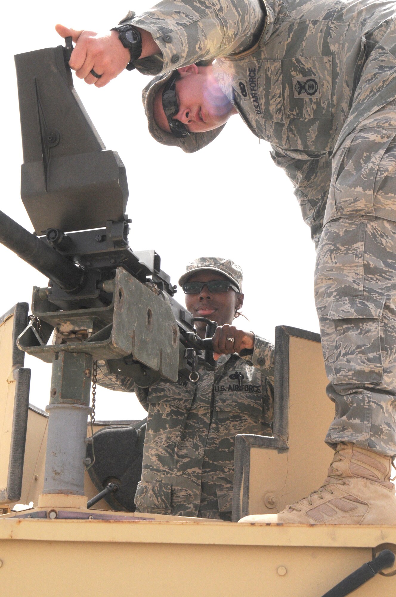 Staff Sgt. Dallas Stephens, a Defender with the 386th Expeditionary Security Forces Squadron, shows Staff Sgt. D'kissy Bristow, a material management specialist with the 386th Expeditionary Logistics Readiness Squadron, the proper operation of the MK 19 automatic grenade launcher. The 386th and 387th ESFS celebrated and honored Police Week with a multitude of events. (U.S. Air Force photo by Staff Sgt. Patrice Clarke)