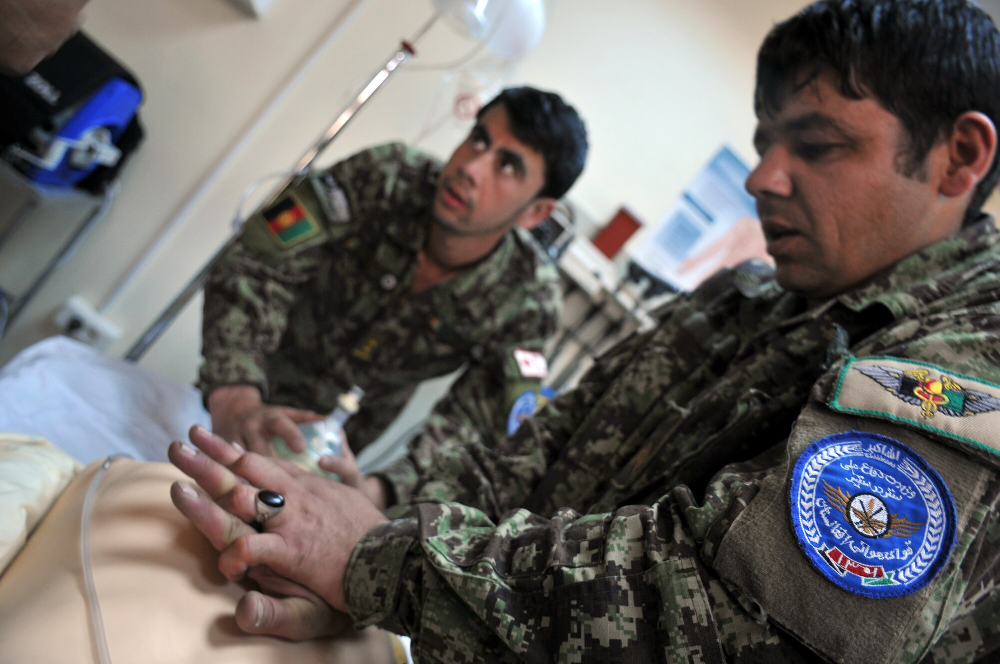 Afghan Air Force Airmen practice cardiopulmonary resuscitation techniques during a first aid class taught by 438th Air Expeditionary Wing medical technicians at the Afghan Air Base in Kabul, Afghanistan.  (U.S. Air Force Photo by Tech. Sgt. Brian E. Christiansen).
