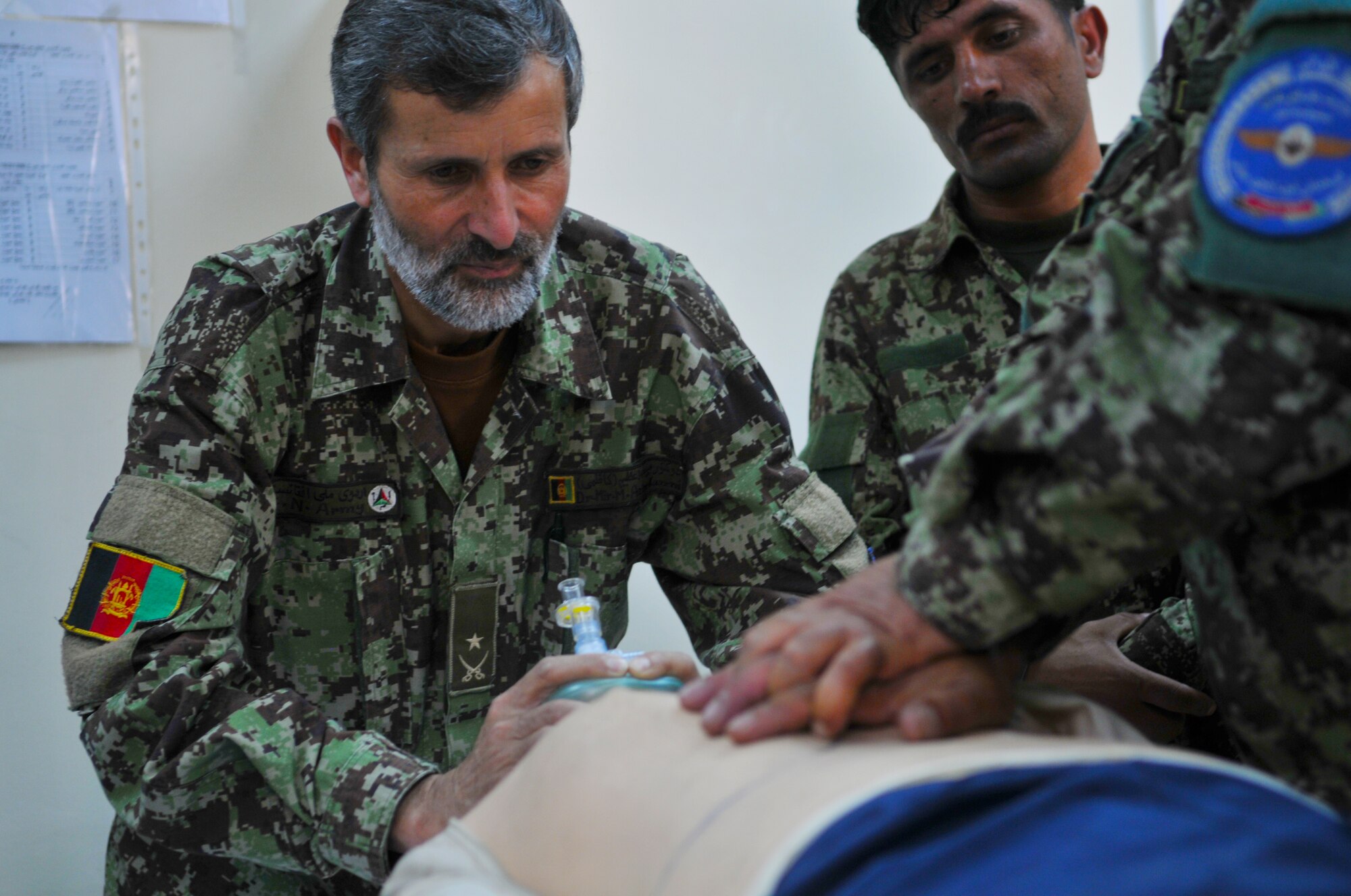 Afghan Air Force Airmen practice cardiopulmonary resuscitation techniques during a first aid class taught by 438th Air Expeditionary Wing medical technicians at the Afghan Air Base in Kabul, Afghanistan.  (U.S. Air Force Photo by Tech. Sgt. Brian E. Christiansen).