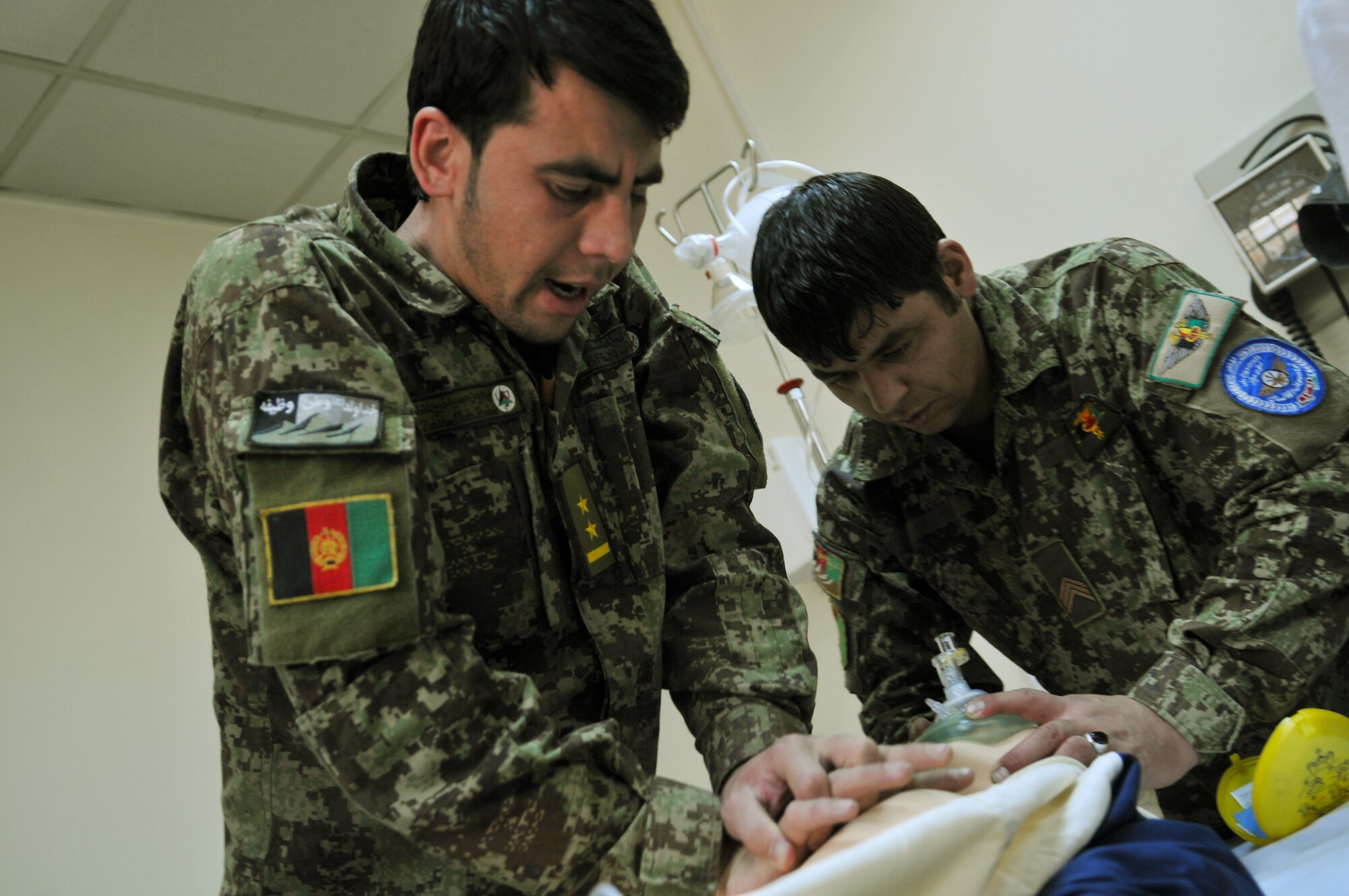Afghan Air Force Airmen practice cardiopulmonary resuscitation techniques during a first aid class taught by 438th Air Expeditionary Wing medical technicians at the Afghan Air Base in Kabul, Afghanistan.  (U.S. Air Force Photo by Tech. Sgt. Brian E. Christiansen).