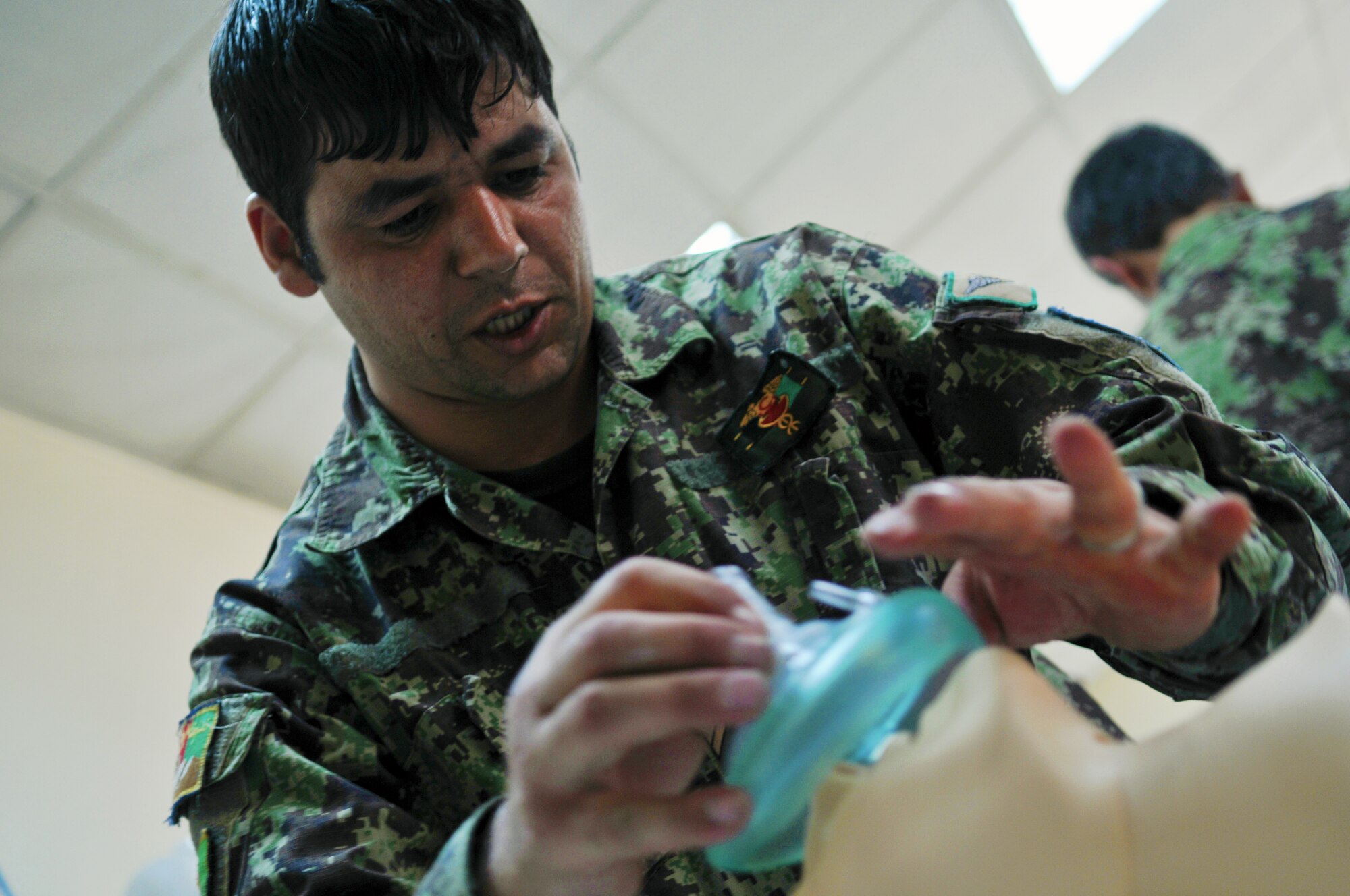 Afghan Air Force Airmen practice cardiopulmonary resuscitation techniques during a first aid class taught by 438th Air Expeditionary Wing medical technicians at the Afghan Air Base in Kabul, Afghanistan.  (U.S. Air Force Photo by Tech. Sgt. Brian E. Christiansen).